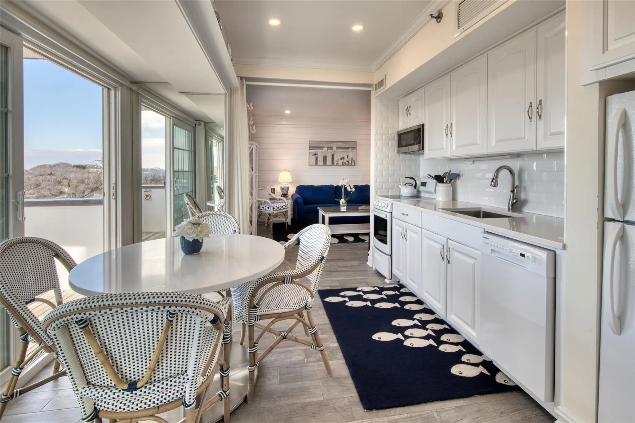 Kitchen featuring tasteful backsplash, sink, white cabinets, ornamental molding, and white appliances Kitchen featuring tasteful backsplash, sink, white cabinets, ornamental molding, and white appliances