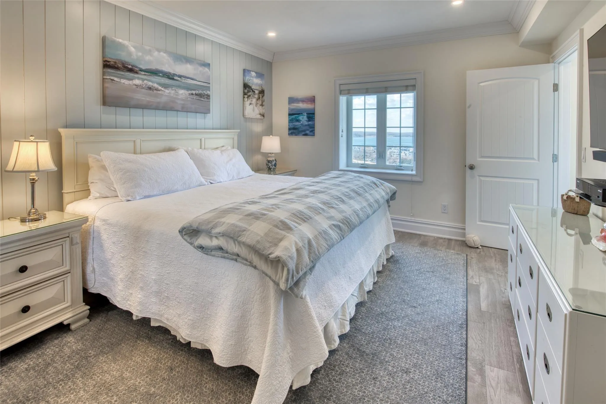 Bedroom featuring crown molding and light hardwood / wood-style floors Bedroom featuring crown molding and light hardwood / wood-style floors