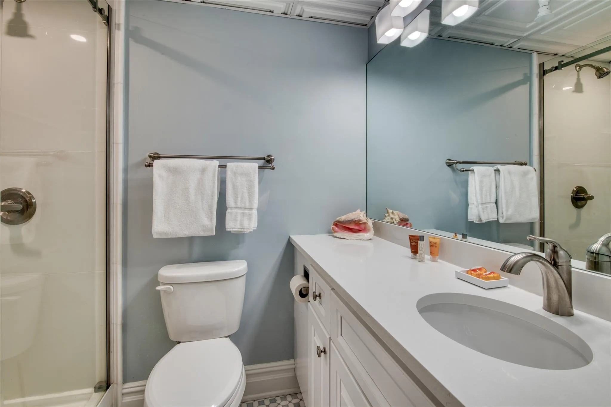 Bathroom featuring vanity, toilet, and an enclosed shower Bathroom featuring vanity, toilet, and an enclosed shower