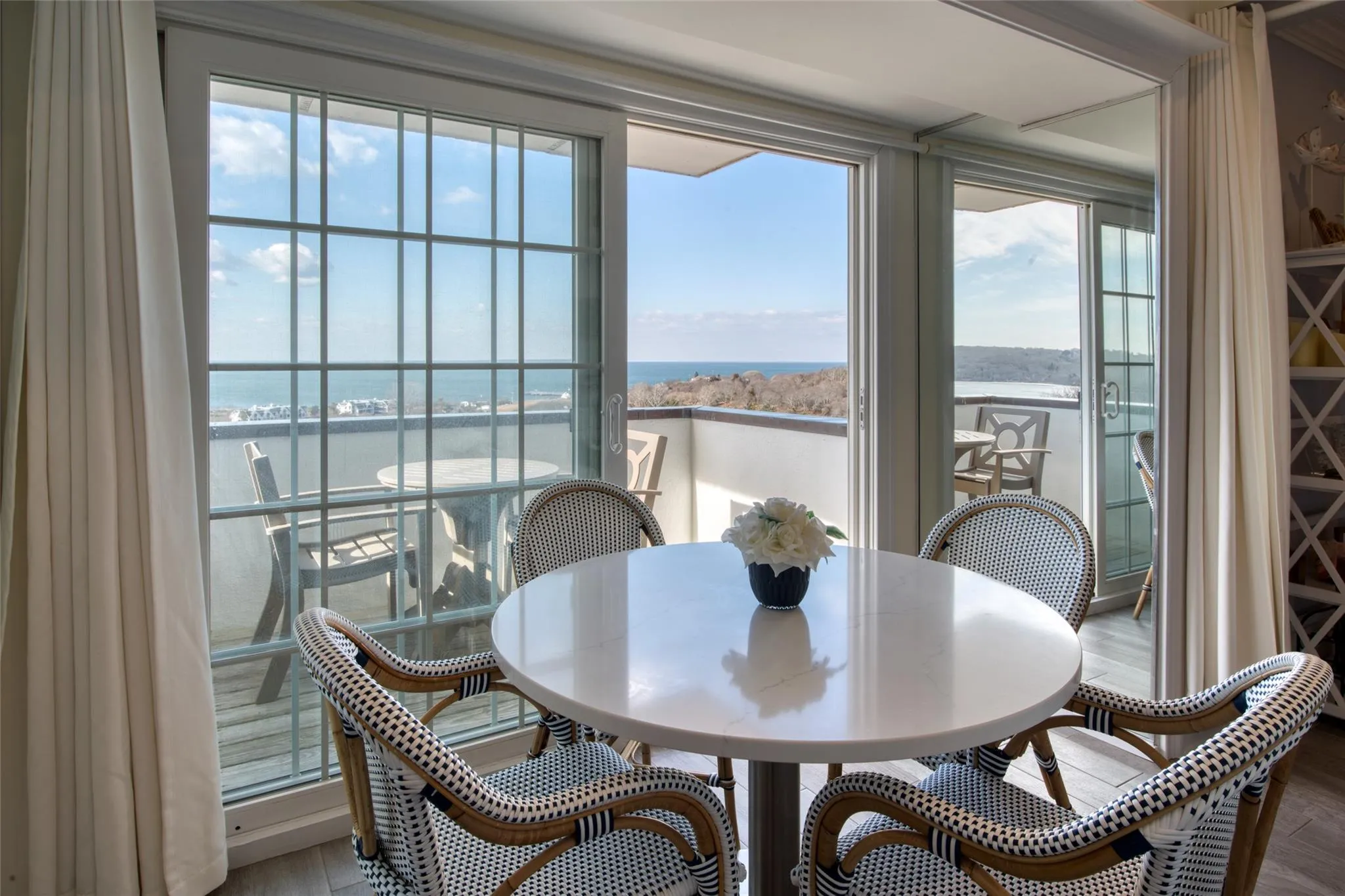 Dining space featuring a water view, a healthy amount of sunlight, and wood-type flooring Dining space featuring a water view, a healthy amount of sunlight, and wood-type flooring