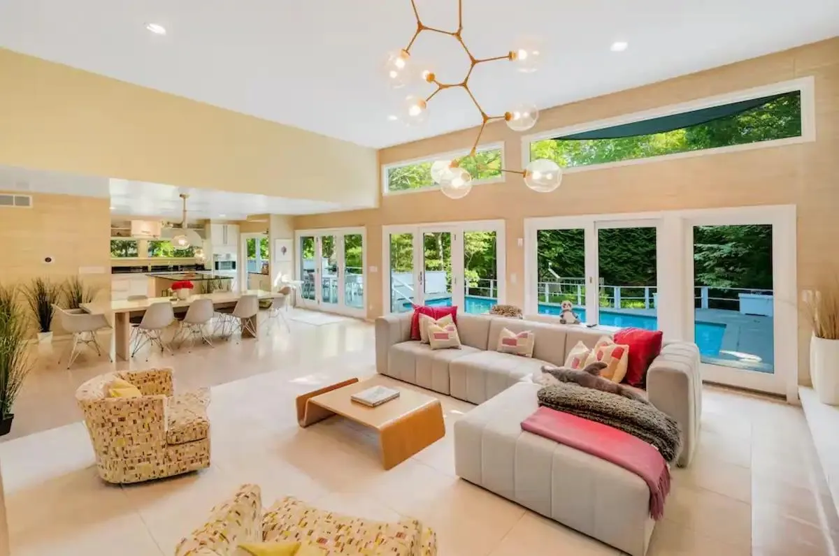 Sunroom with french doors and a notable chandelier Sunroom with french doors and a notable chandelier
