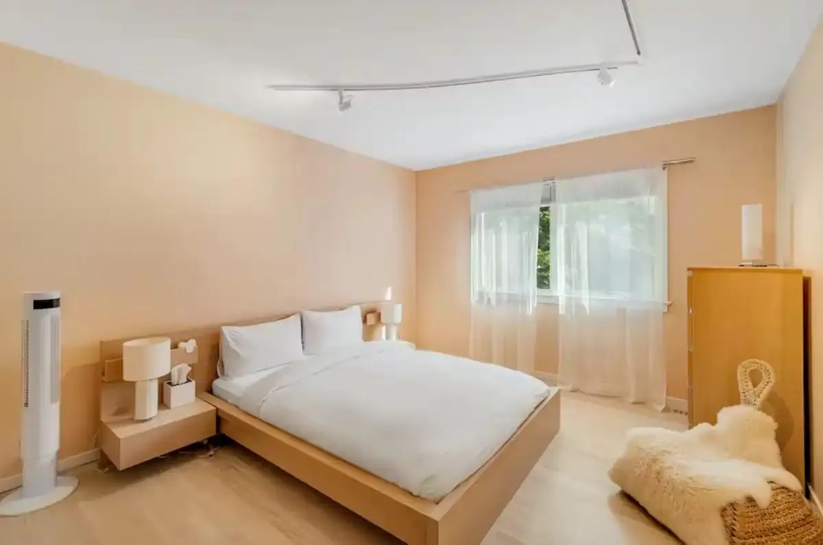 Bedroom with track lighting and light hardwood / wood-style floors Bedroom with track lighting and light hardwood / wood-style floors