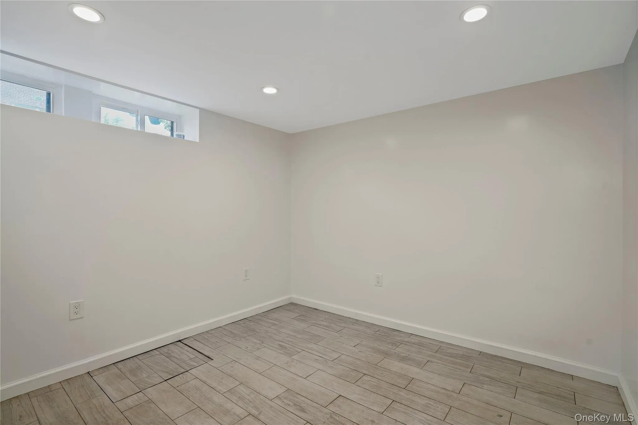 Unfurnished room featuring recessed lighting and light wood-style flooring Unfurnished room featuring recessed lighting and light wood-style flooring