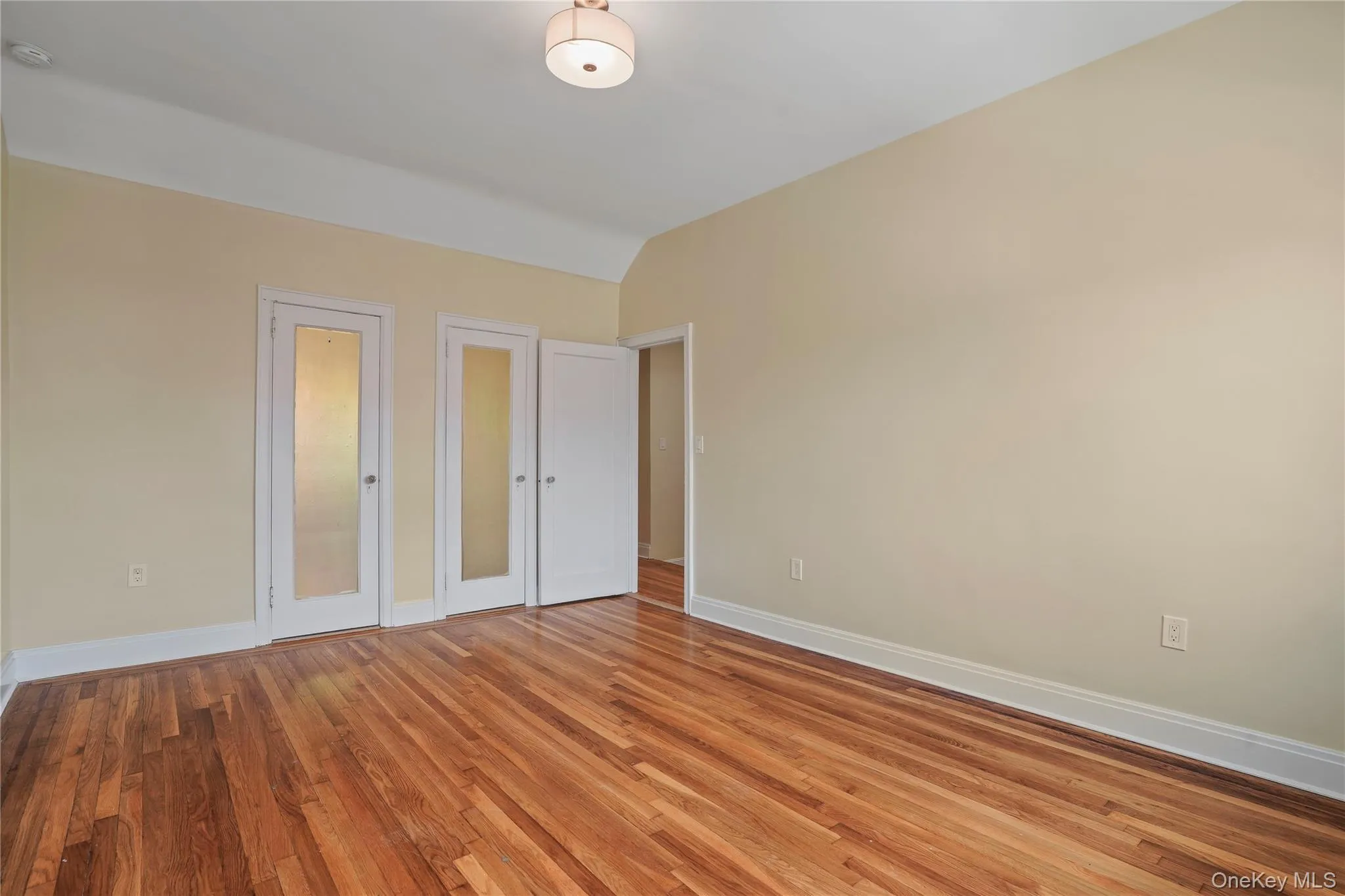 Unfurnished bedroom featuring light wood-style floors and baseboards Unfurnished bedroom featuring light wood-style floors and baseboards