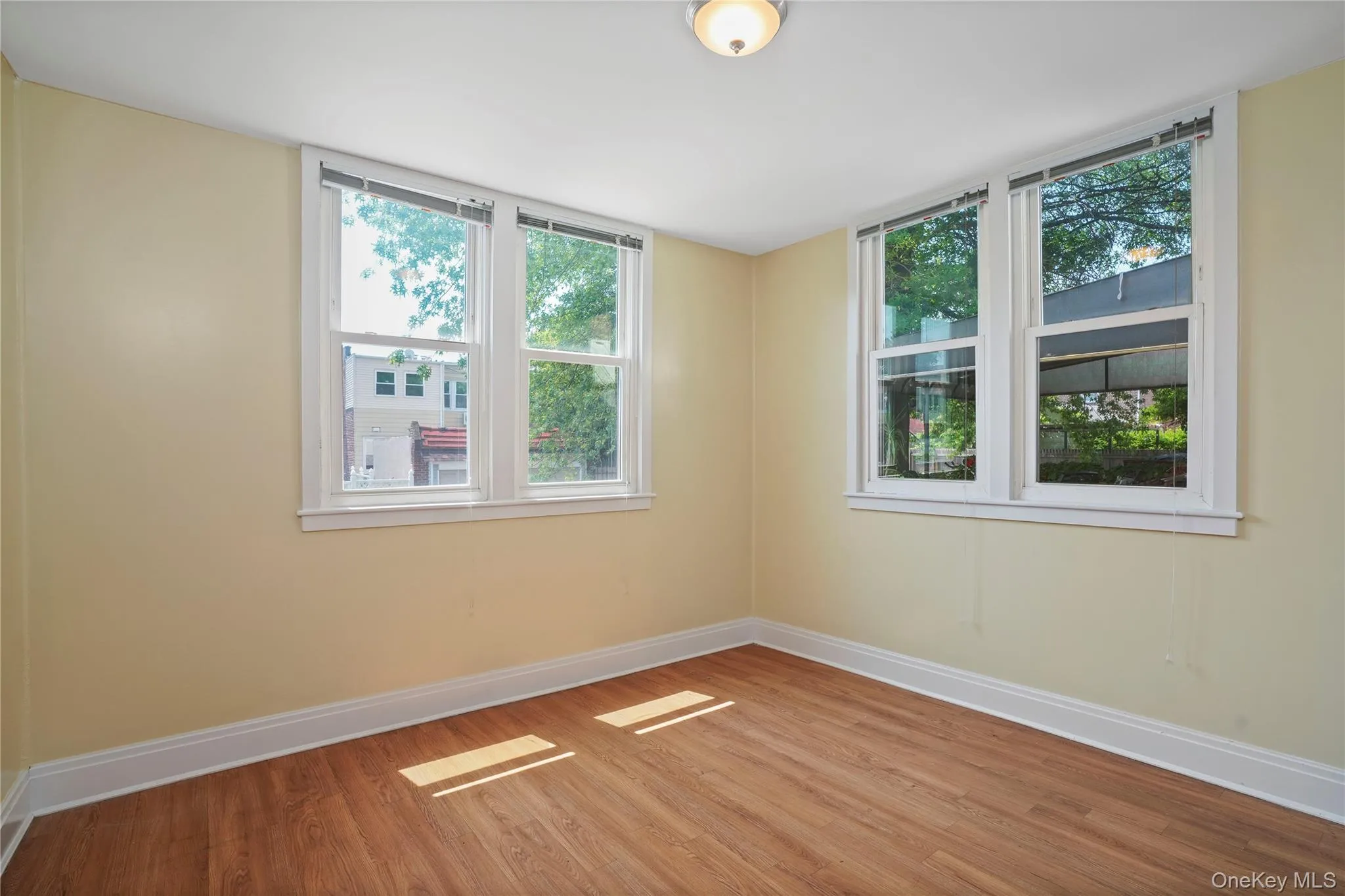 Empty room with baseboards and wood finished floors Empty room with baseboards and wood finished floors