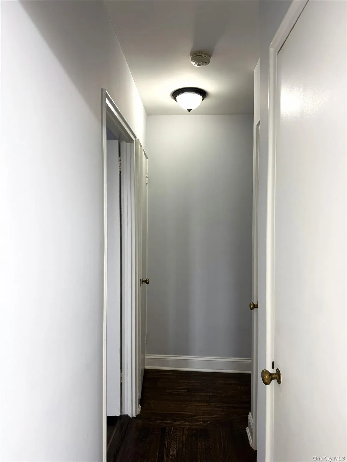 Hall featuring dark wood-type flooring Hall featuring dark wood-type flooring