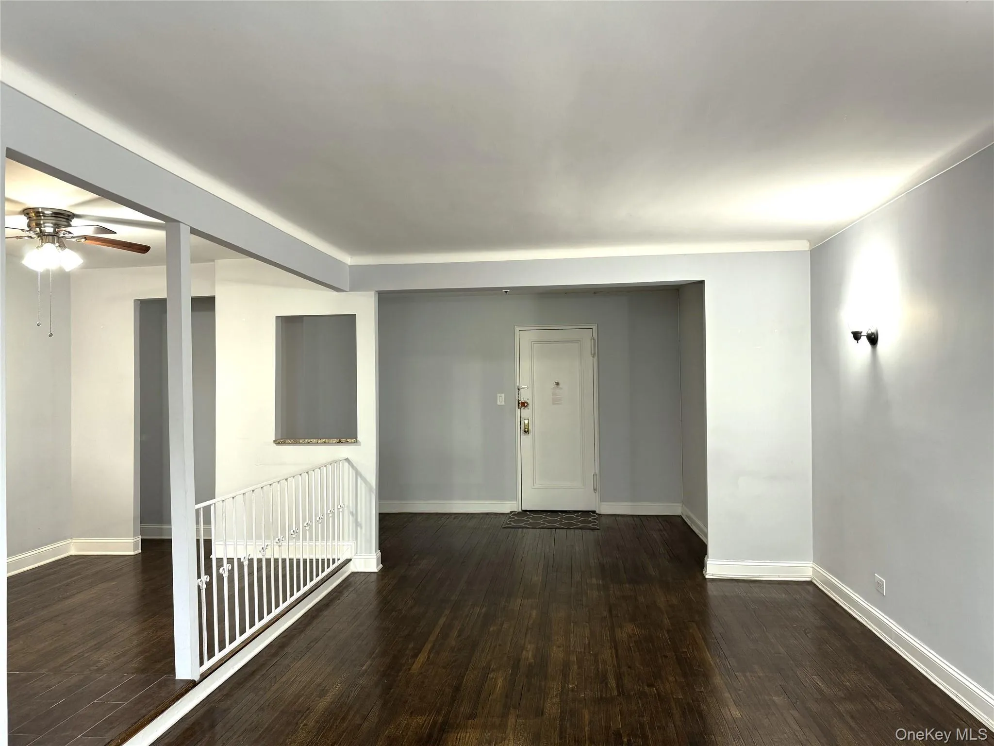 Unfurnished room featuring dark wood-type flooring and ceiling fan Unfurnished room featuring dark wood-type flooring and ceiling fan