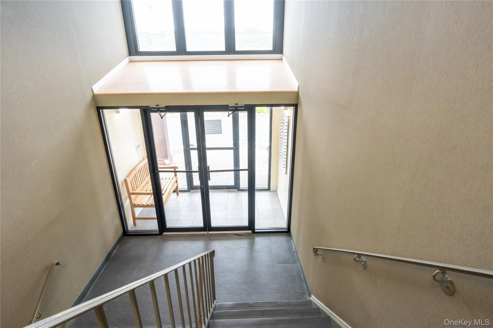 Staircase featuring wood finished floors Staircase featuring wood finished floors