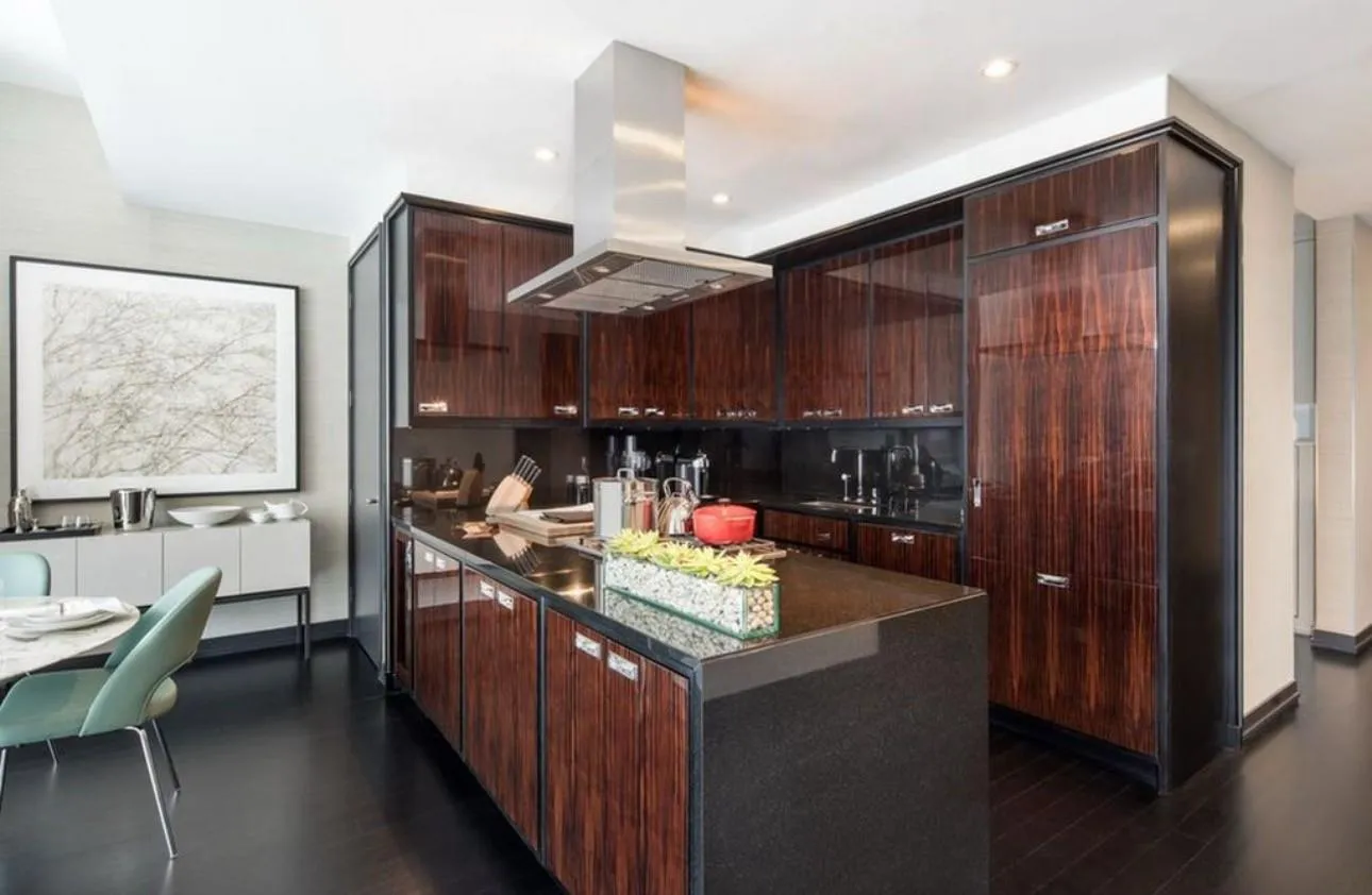 Kitchen featuring dark hardwood / wood-style floors, sink, island range hood, and dark brown cabinetry Kitchen featuring dark hardwood / wood-style floors, sink, island range hood, and dark brown cabinetry