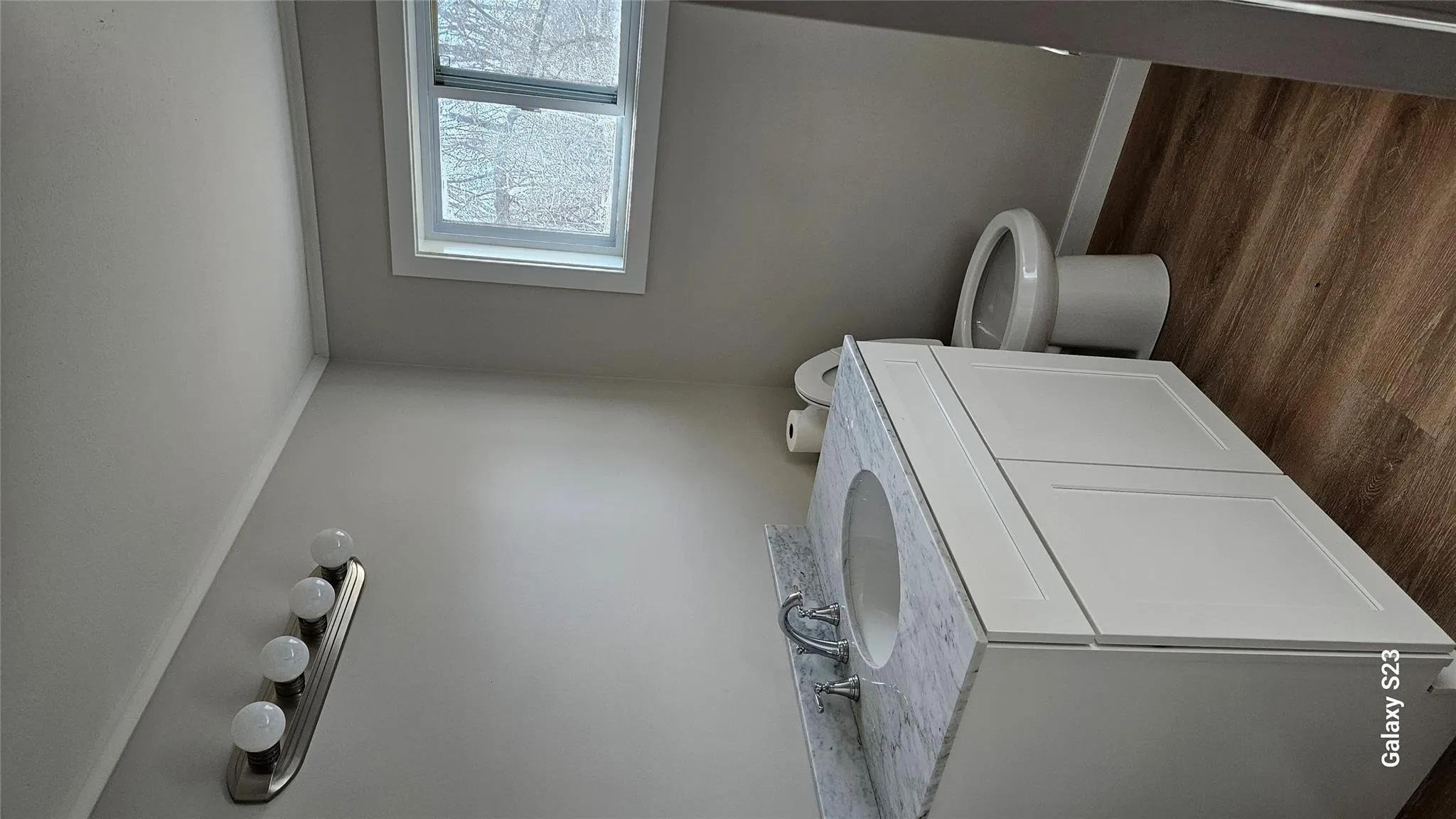 Bathroom featuring ornamental molding, vanity, toilet, and wood-type flooring Bathroom featuring ornamental molding, vanity, toilet, and wood-type flooring