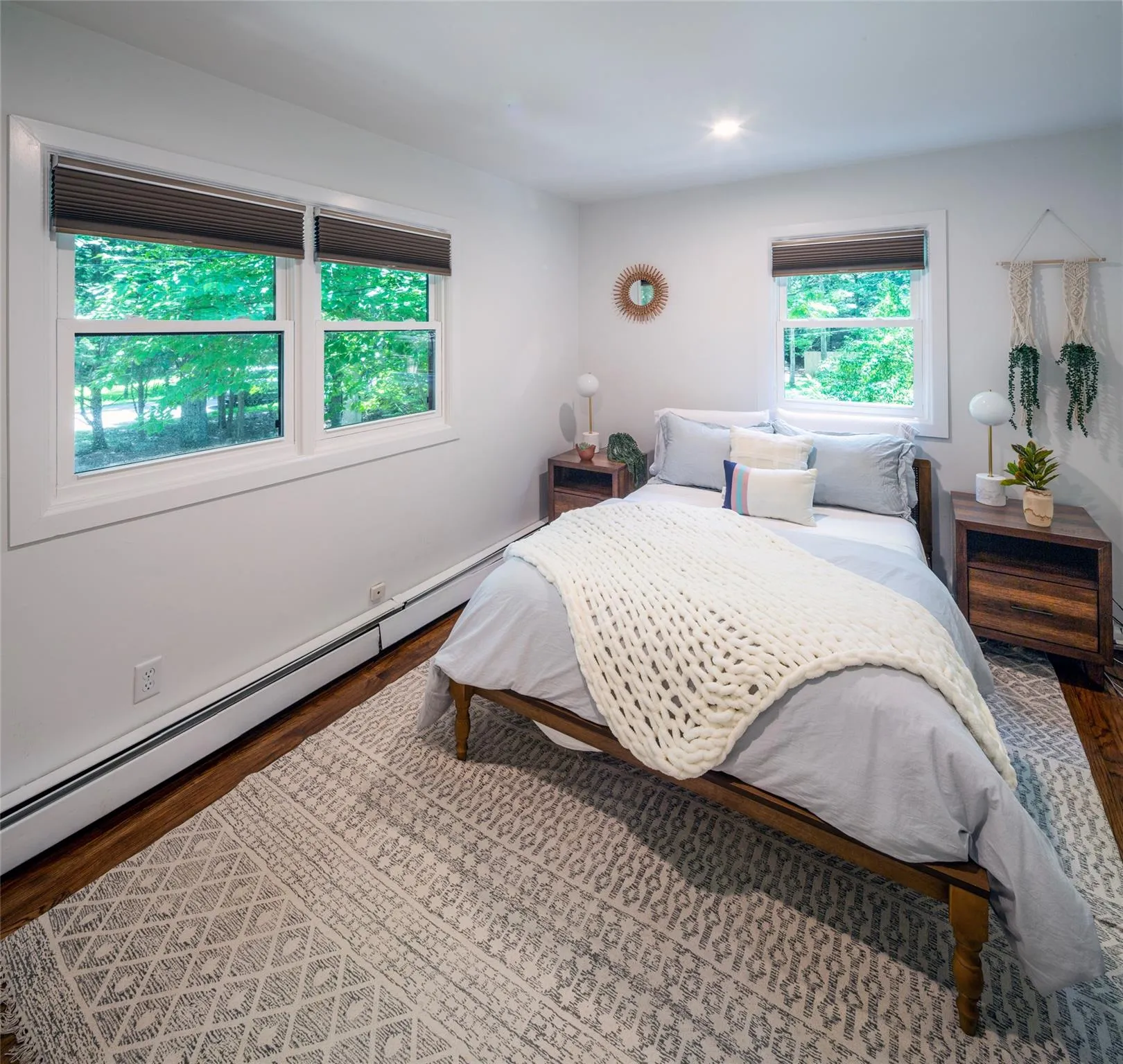Bedroom with a baseboard radiator and hardwood / wood-style floors Bedroom with a baseboard radiator and hardwood / wood-style floors