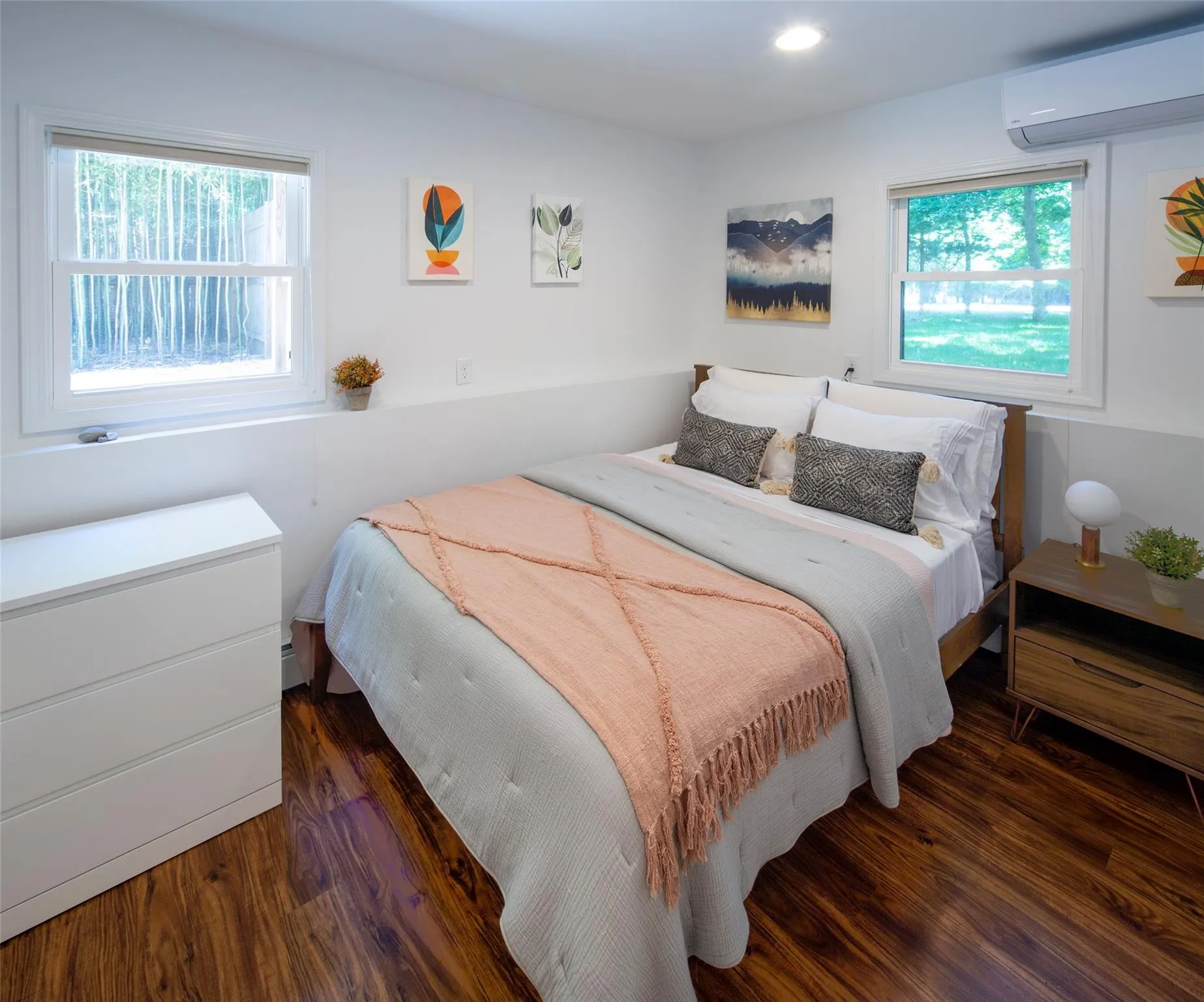 Bedroom with dark hardwood / wood-style flooring and a wall unit AC Bedroom with dark hardwood / wood-style flooring and a wall unit AC