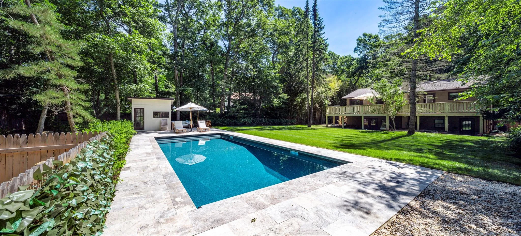 View of swimming pool with a yard, an outbuilding, and a wooden deck View of swimming pool with a yard, an outbuilding, and a wooden deck
