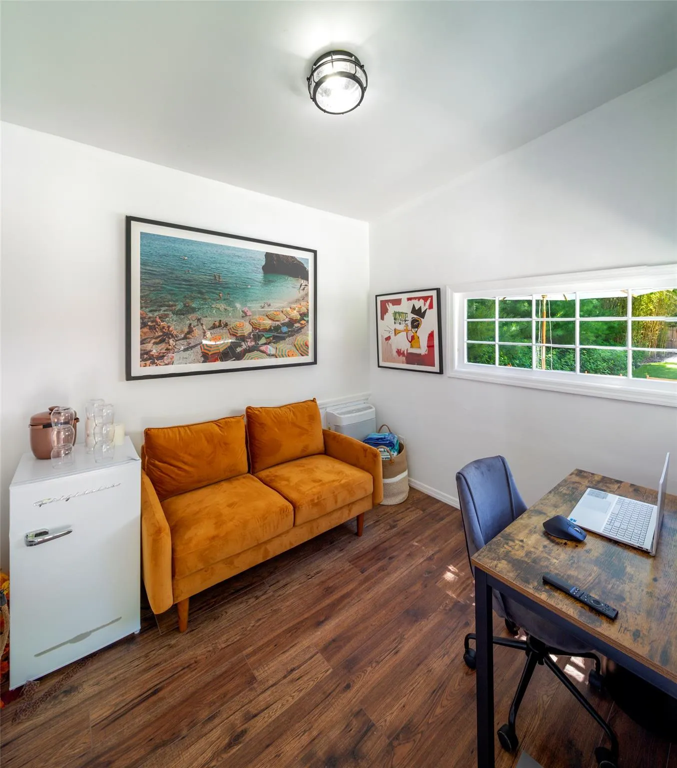 Home office with dark hardwood / wood-style flooring Home office with dark hardwood / wood-style flooring