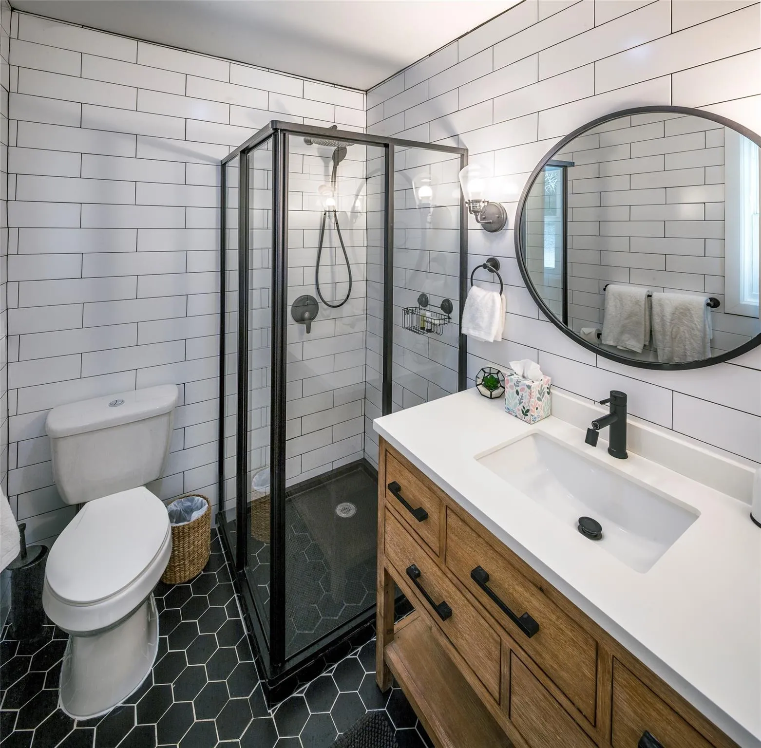 Bathroom featuring walk in shower, vanity, and tile walls Bathroom featuring walk in shower, vanity, and tile walls