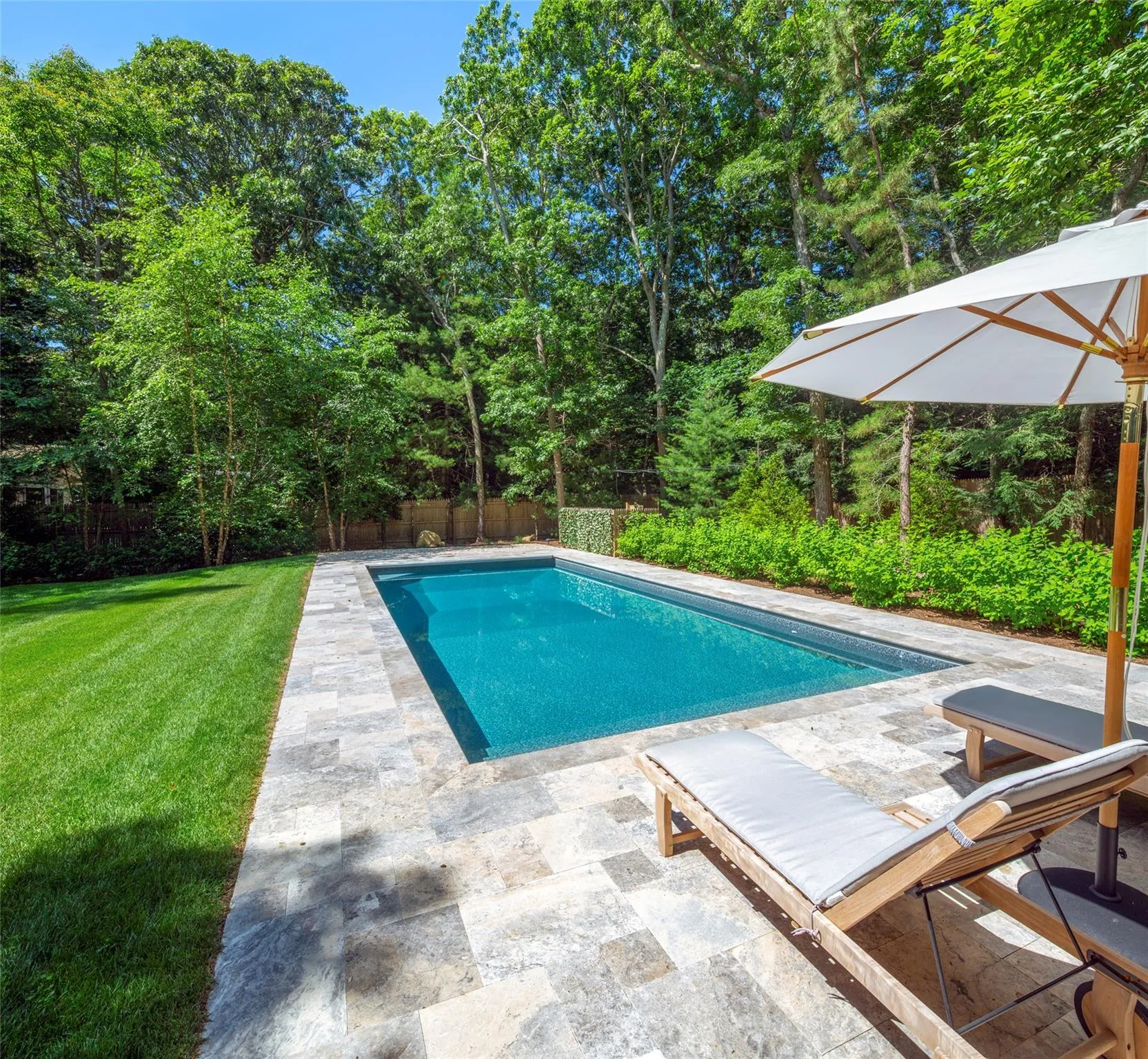 View of swimming pool with a yard and a patio area View of swimming pool with a yard and a patio area