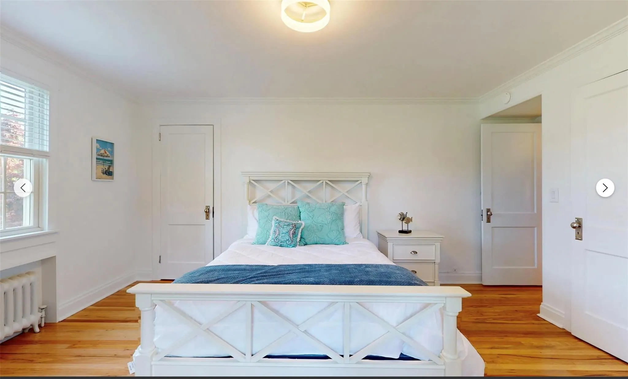 Bedroom featuring crown molding, radiator, and light hardwood / wood-style floors Bedroom featuring crown molding, radiator, and light hardwood / wood-style floors