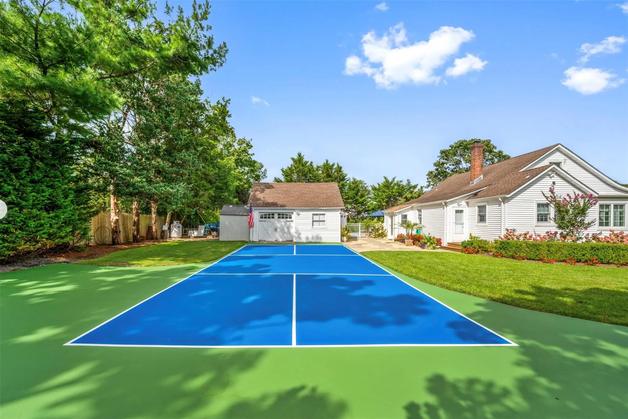 View of sport court with a lawn View of sport court with a lawn