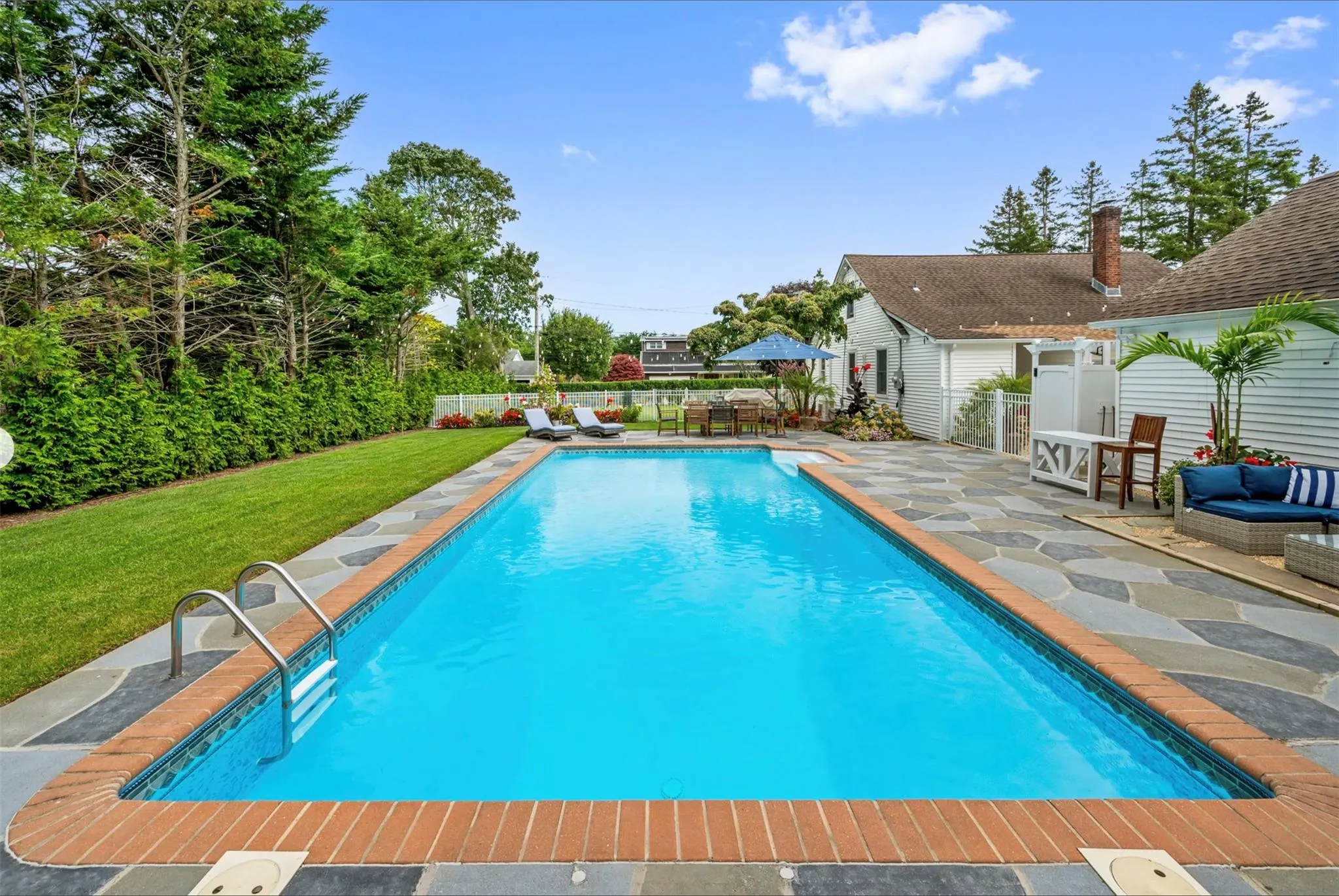 View of pool with a patio area and a lawn View of pool with a patio area and a lawn