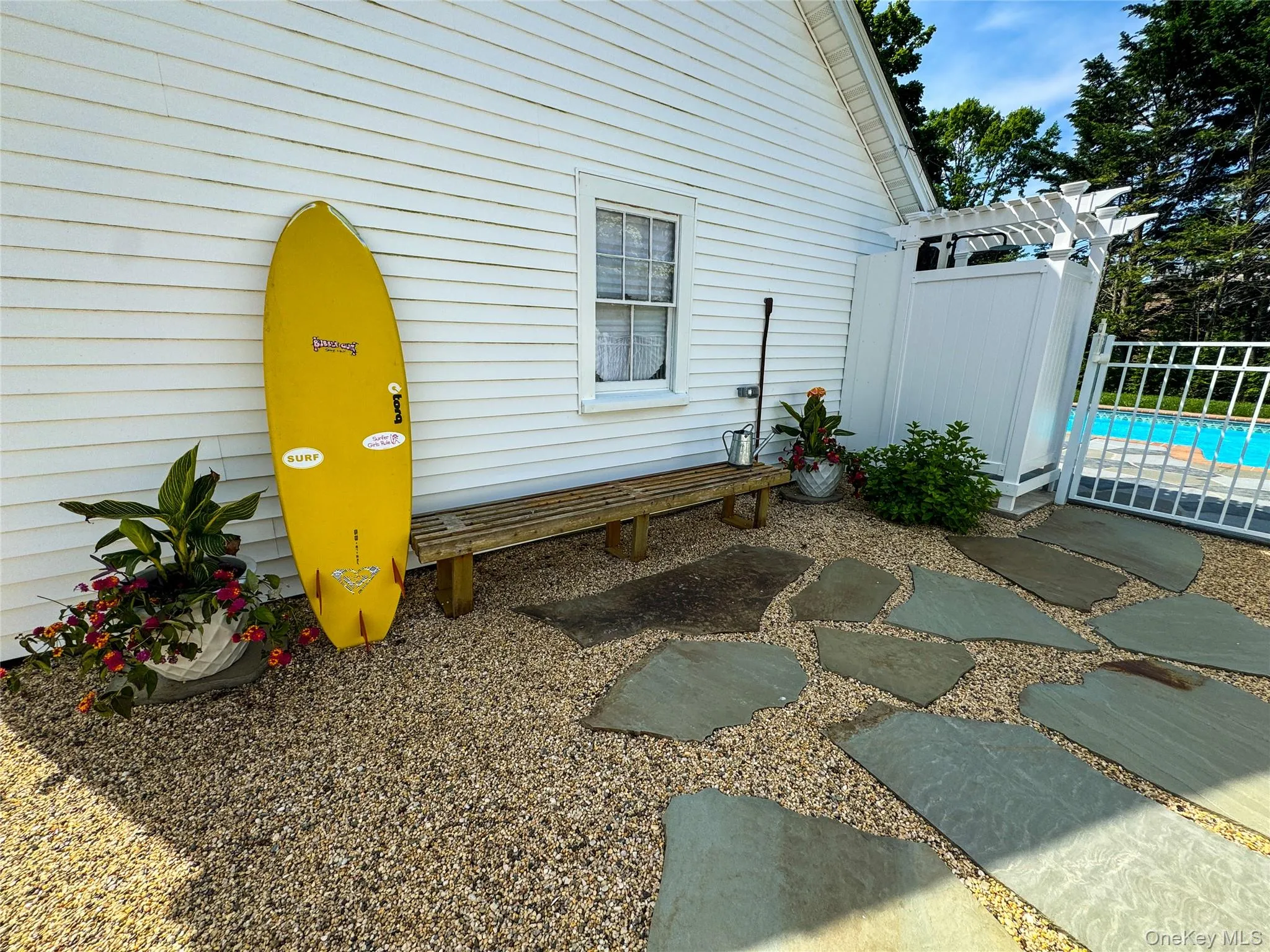 View of home's exterior featuring a fenced in pool View of home's exterior featuring a fenced in pool