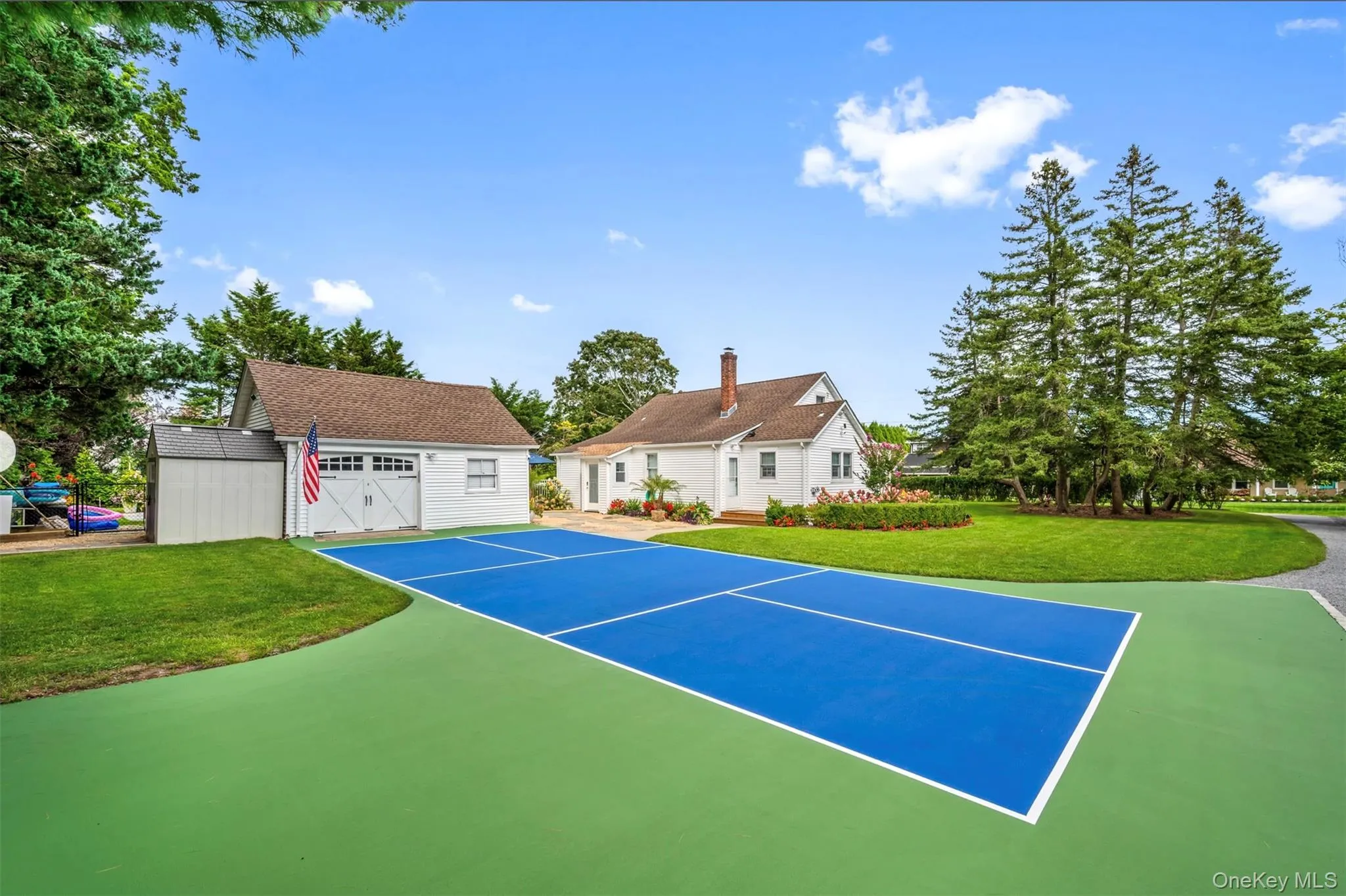 View of sport court with an outbuilding and a lawn View of sport court with an outbuilding and a lawn