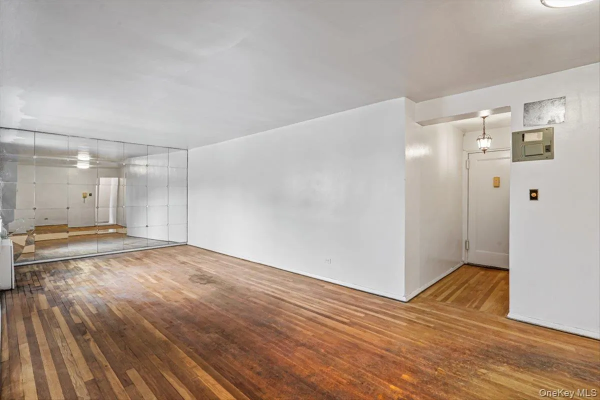 Unfurnished living room featuring wood-type flooring Unfurnished living room featuring wood-type flooring