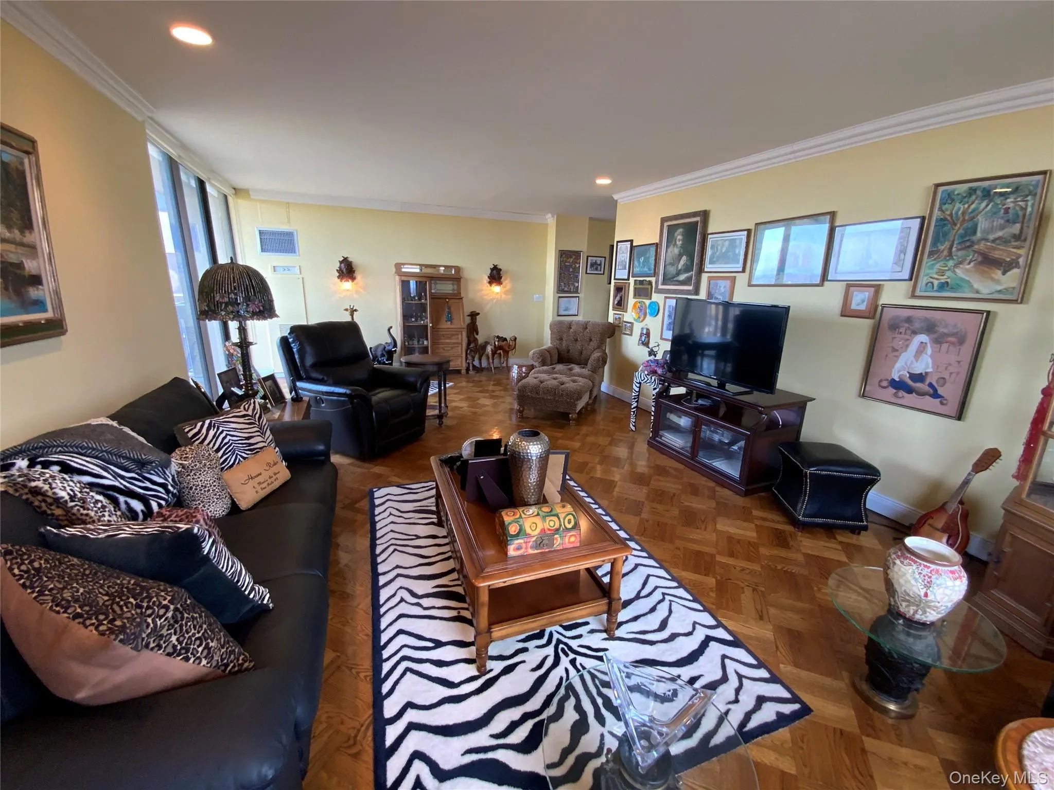 Living room featuring ornamental molding and recessed lighting Living room featuring ornamental molding and recessed lighting