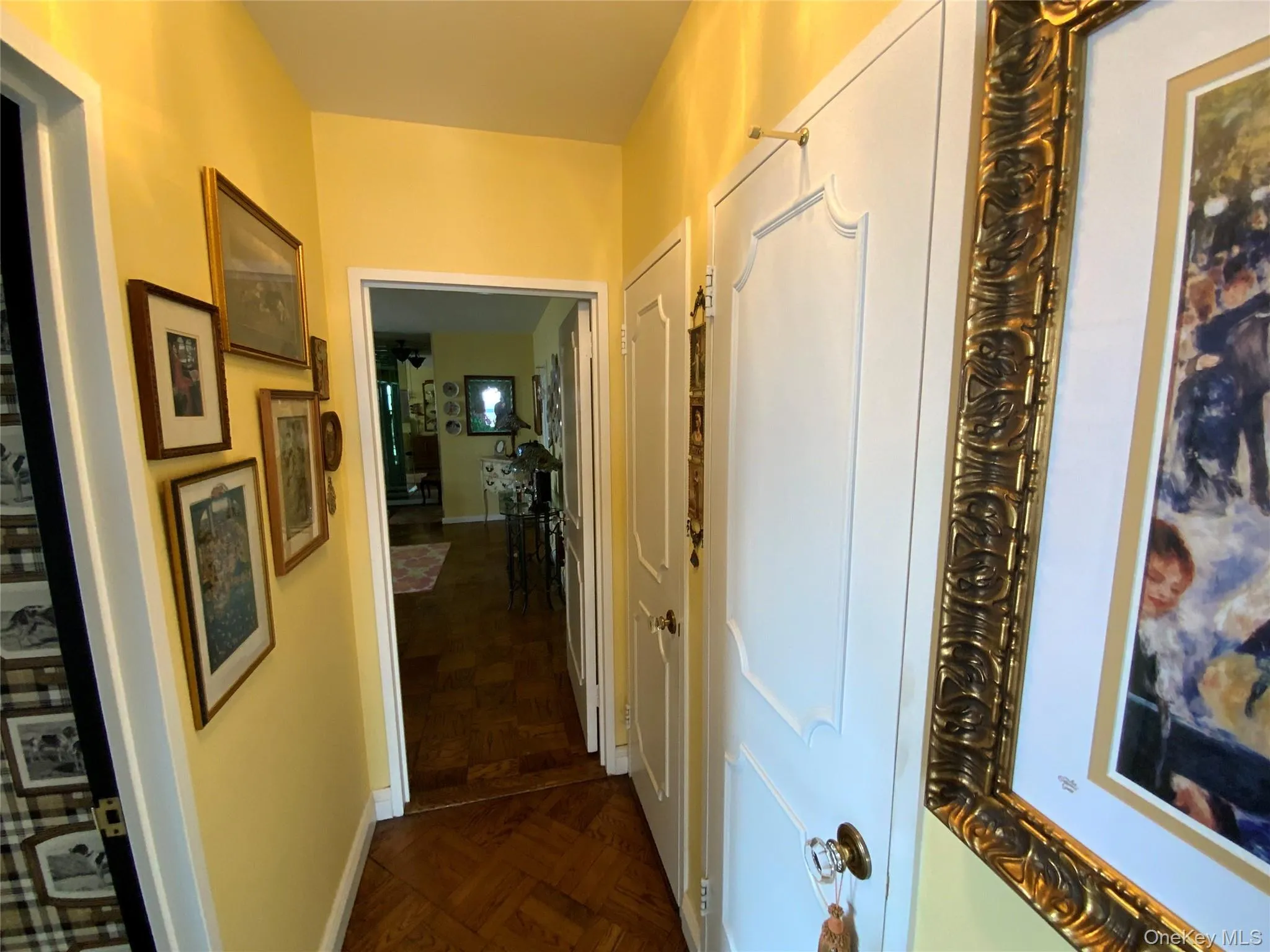 Hallway featuring dark parquet flooring Hallway featuring dark parquet flooring