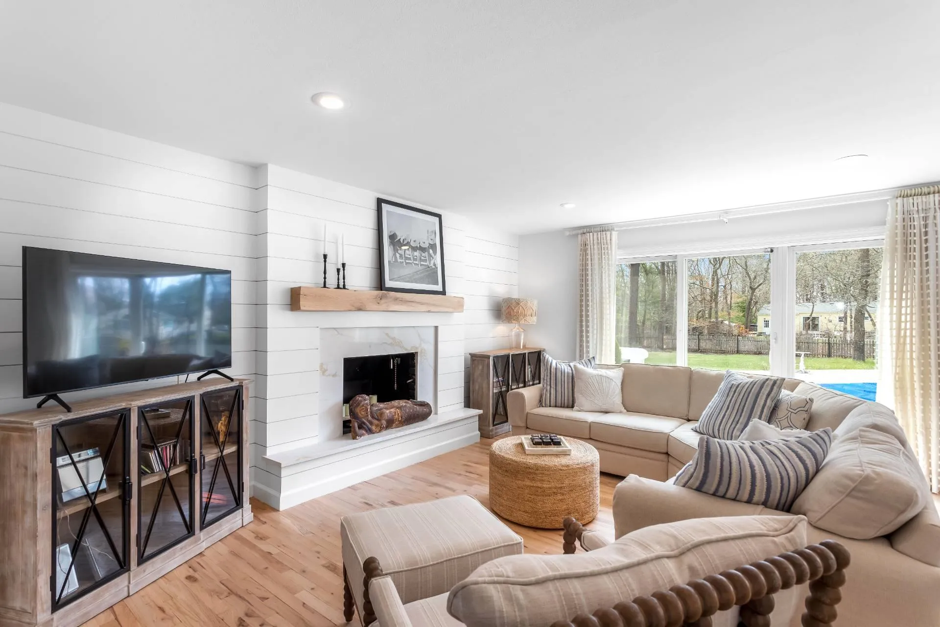 Living room featuring a fireplace and light hardwood / wood-style floors Living room featuring a fireplace and light hardwood / wood-style floors