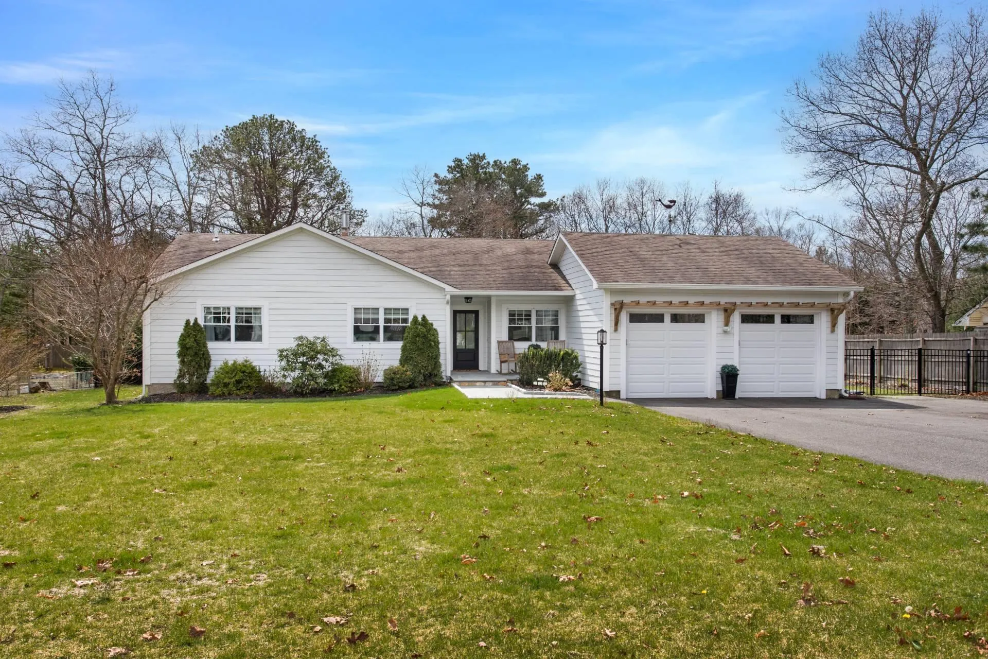 Single story home with a garage and a front yard Single story home with a garage and a front yard