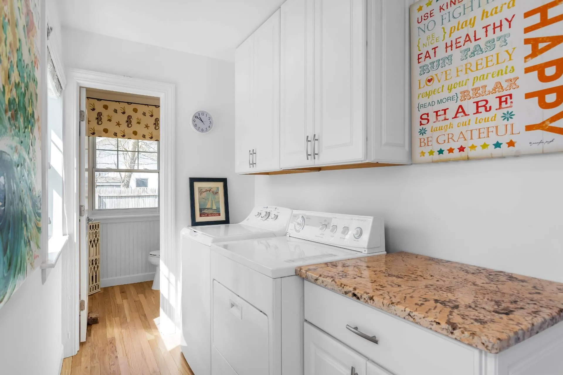 Clothes washing area featuring cabinets, washer and dryer, and light hardwood / wood-style flooring Clothes washing area featuring cabinets, washer and dryer, and light hardwood / wood-style flooring