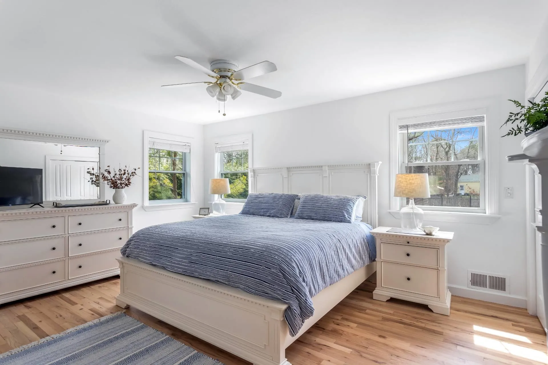 Bedroom featuring ceiling fan and light hardwood / wood-style floors Bedroom featuring ceiling fan and light hardwood / wood-style floors