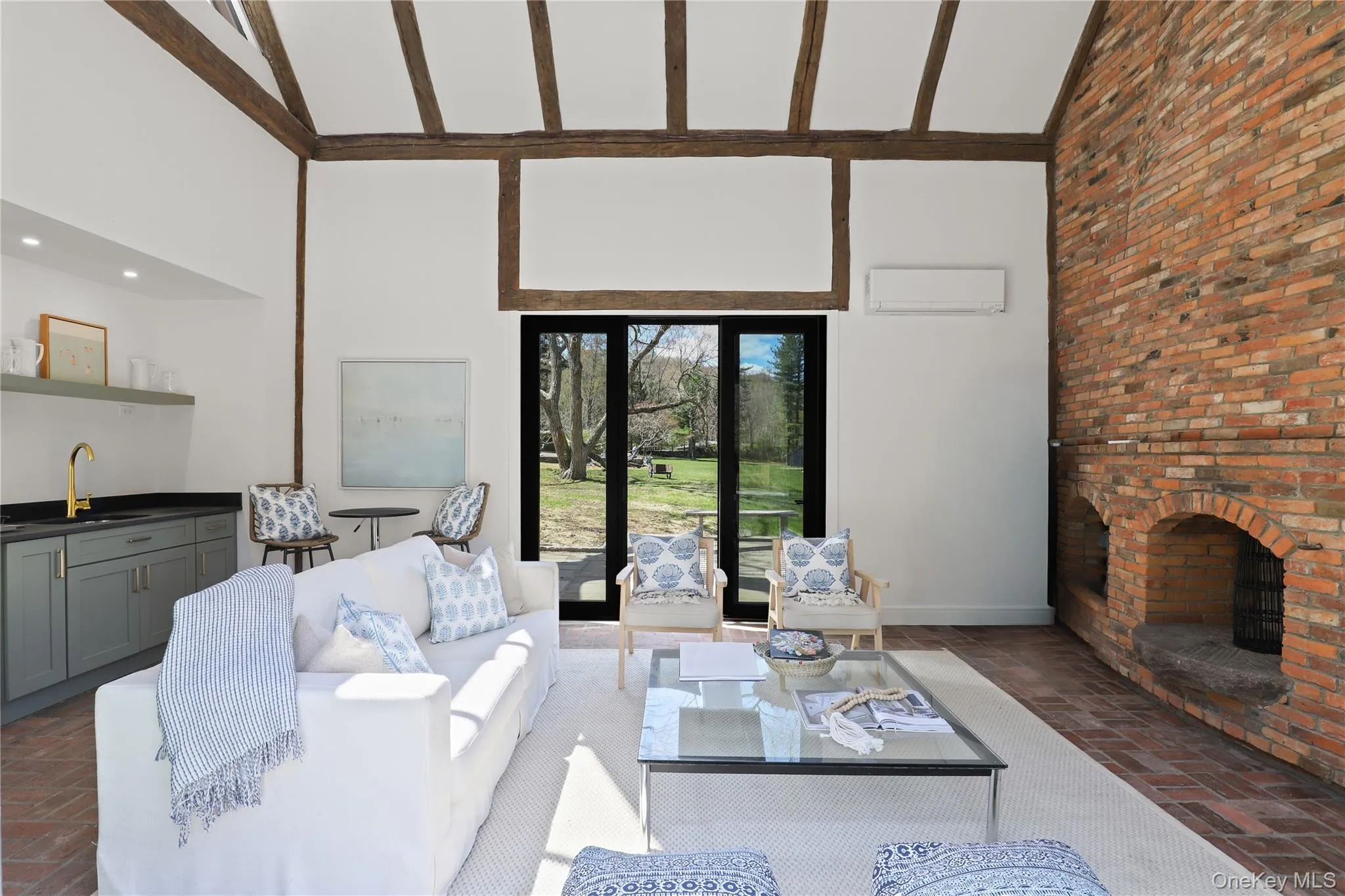 Interior of pool house with floor to ceiling brick fireplace, wet bar and full bath Interior of pool house with floor to ceiling brick fireplace, wet bar and full bath