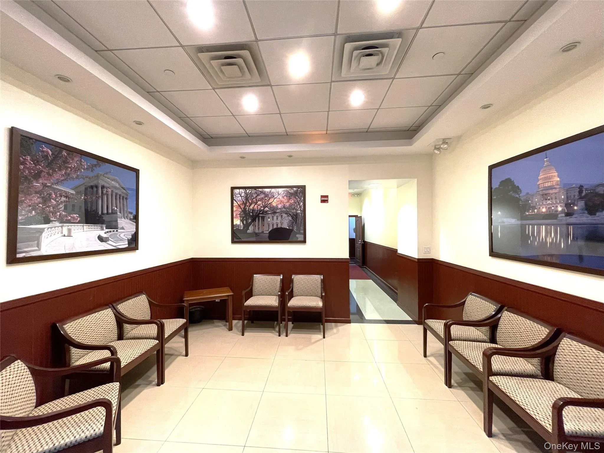 Lobby featuring wainscoting, wooden walls, and a drop ceiling Lobby featuring wainscoting, wooden walls, and a drop ceiling