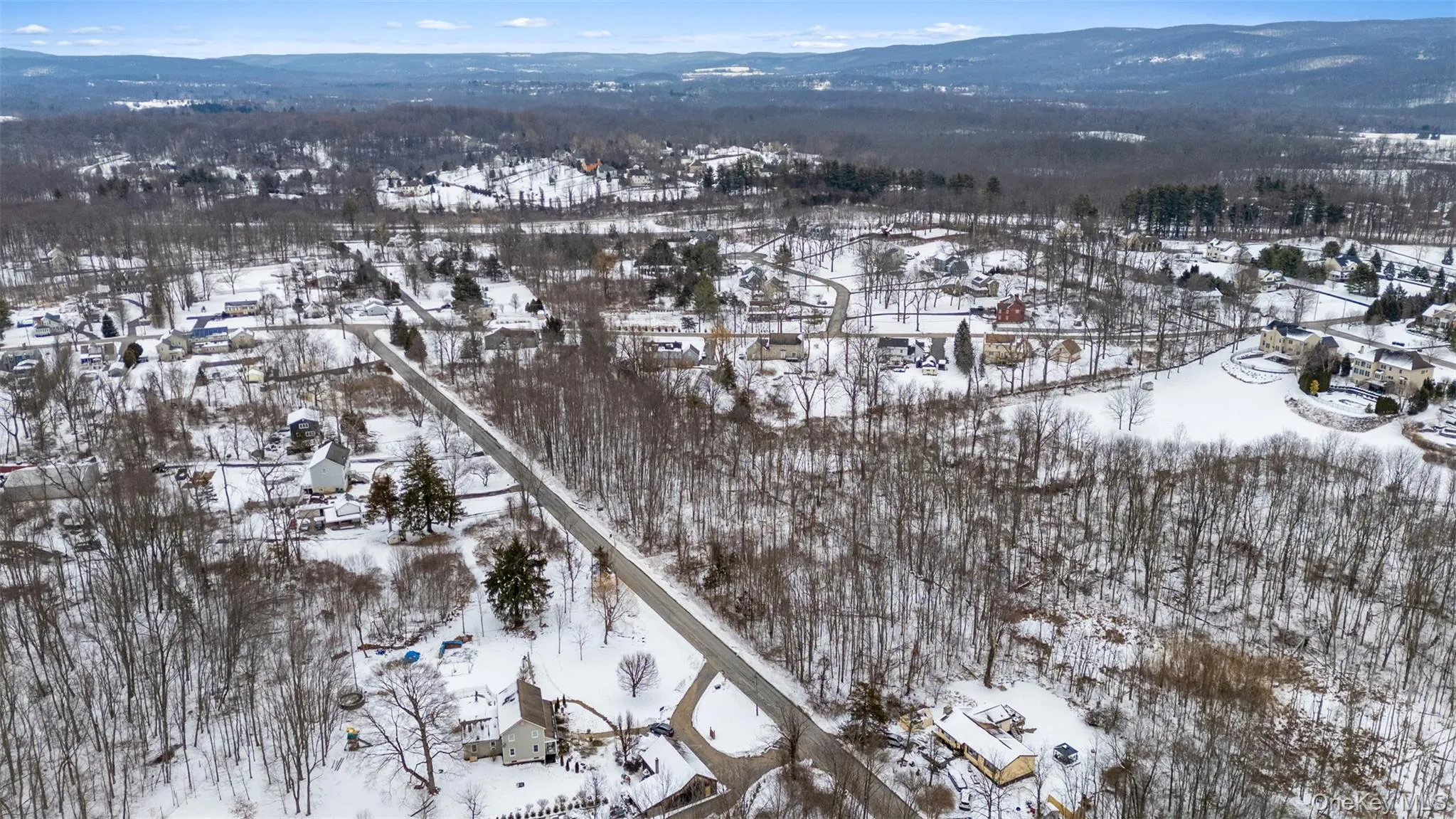 Snowy aerial view with a mountain view Snowy aerial view with a mountain view