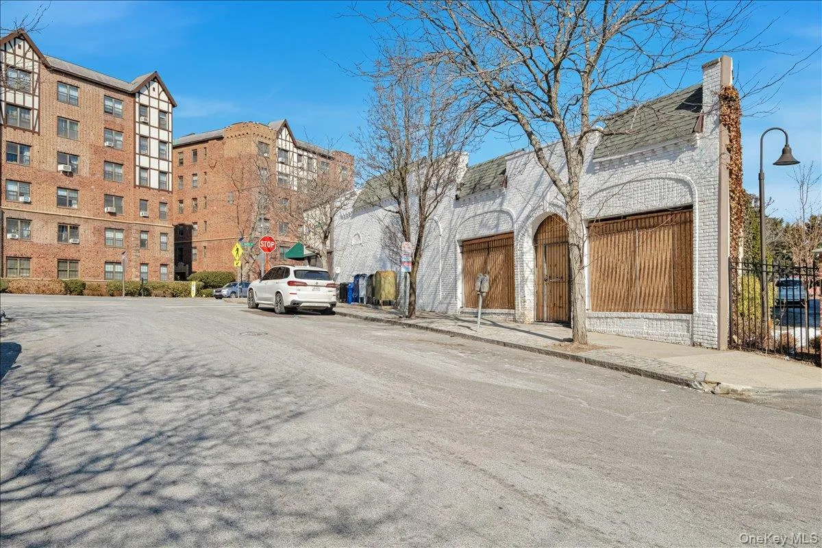 View of road with curbs, sidewalks, and street lights View of road with curbs, sidewalks, and street lights