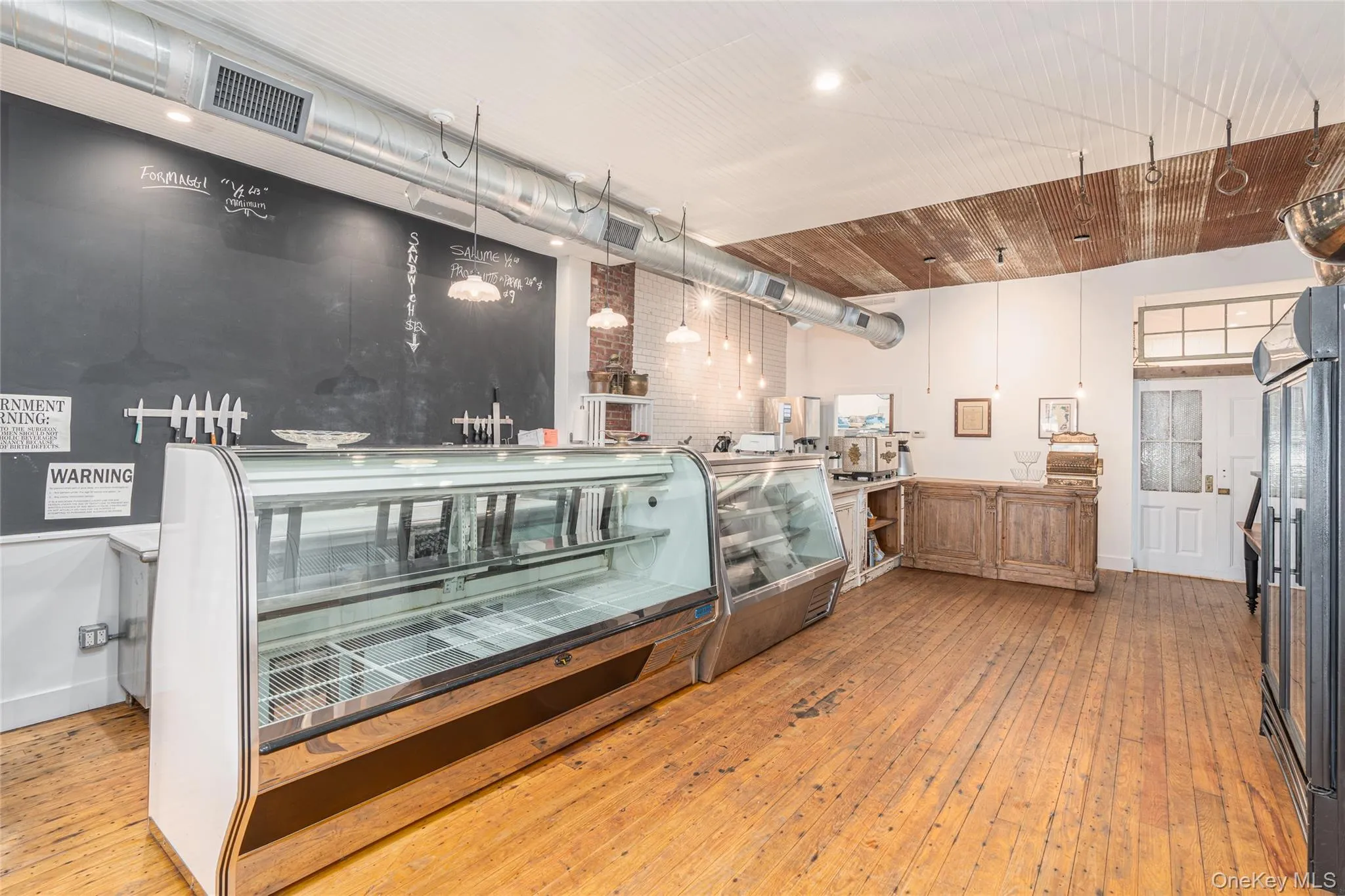 Kitchen featuring hanging light fixtures and light hardwood / wood-style floors Kitchen featuring hanging light fixtures and light hardwood / wood-style floors