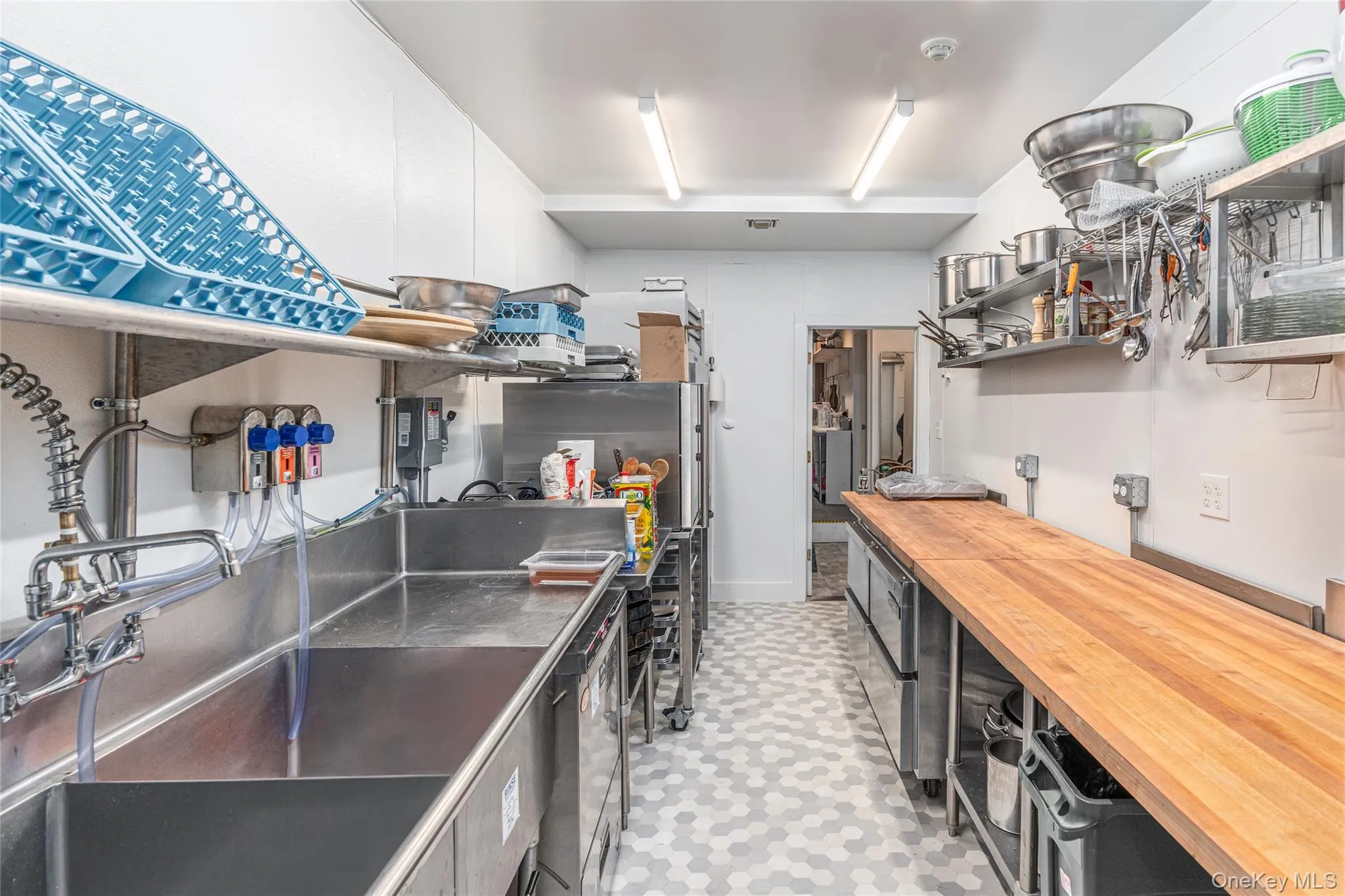 Kitchen featuring butcher block countertops and sink Kitchen featuring butcher block countertops and sink