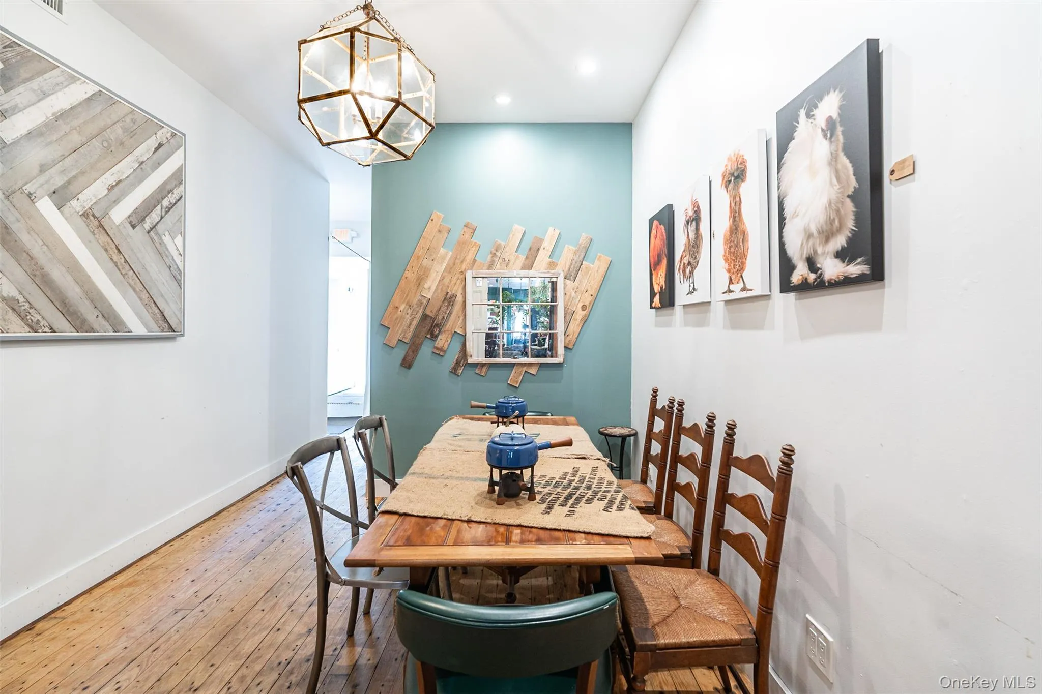 Dining room with wood-type flooring and an inviting chandelier Dining room with wood-type flooring and an inviting chandelier
