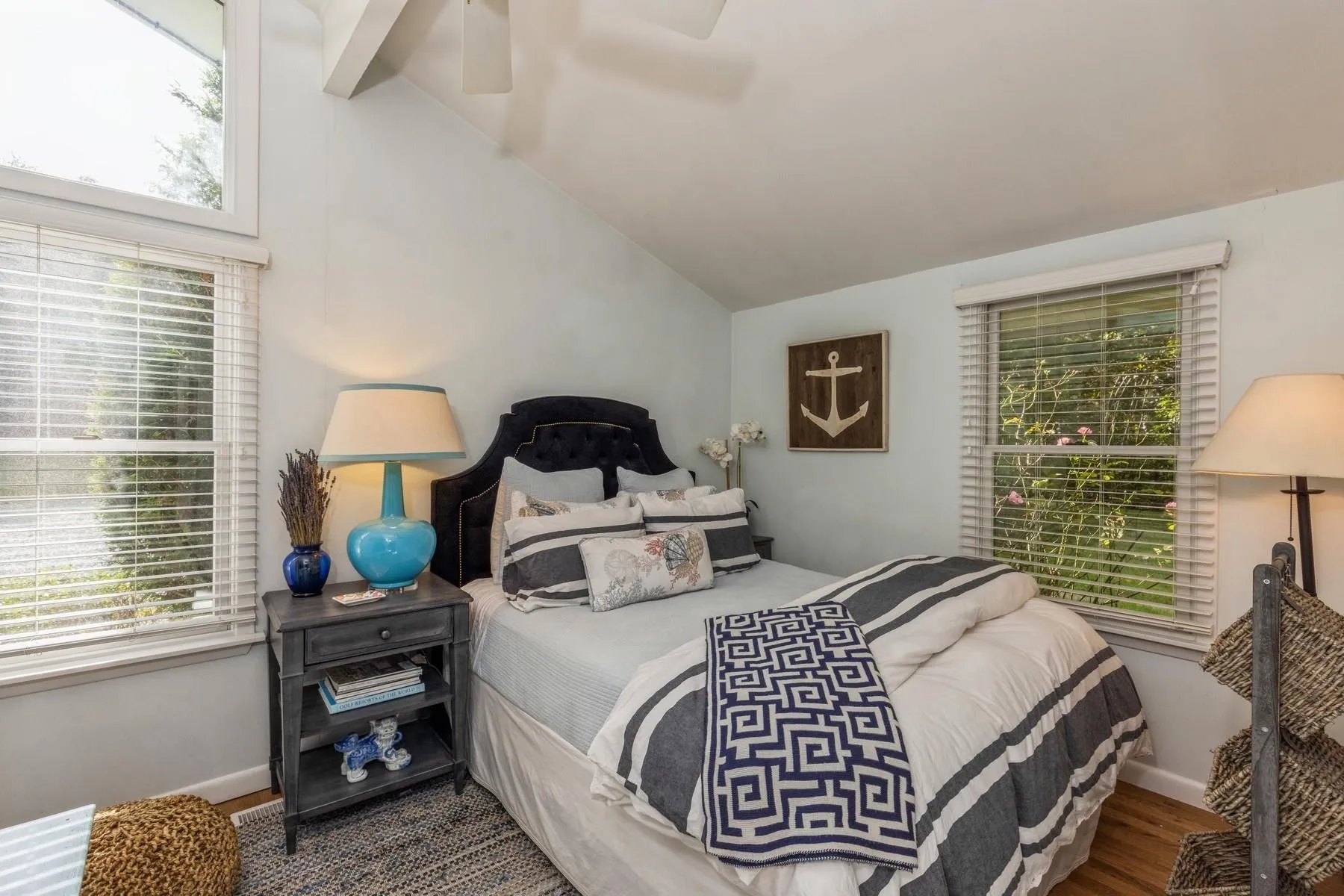 Bedroom featuring hardwood / wood-style flooring, lofted ceiling, and multiple windows - Queen Bed Bedroom featuring hardwood / wood-style flooring, lofted ceiling, and multiple windows - Queen Bed