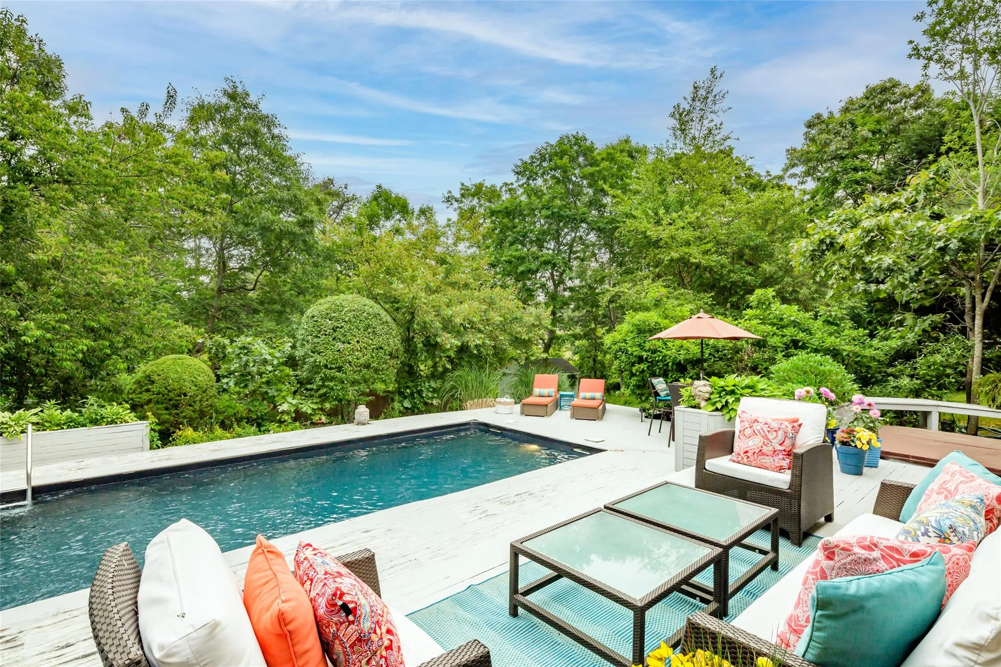 Pool with an outdoor hangout area and a patio Pool with an outdoor hangout area and a patio