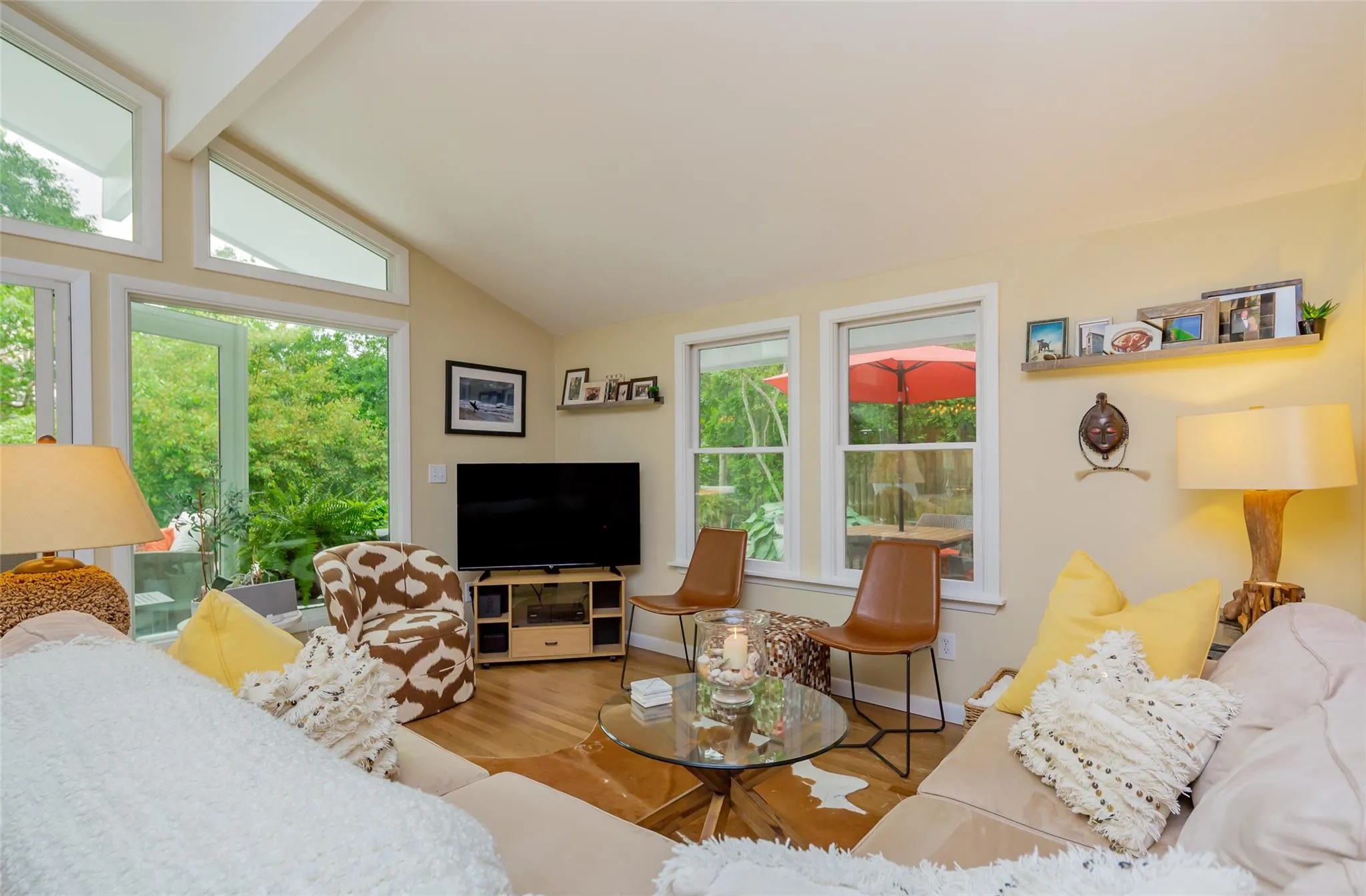 Living room featuring baseboards, wood finished floors, and vaulted ceiling with beams Living room featuring baseboards, wood finished floors, and vaulted ceiling with beams