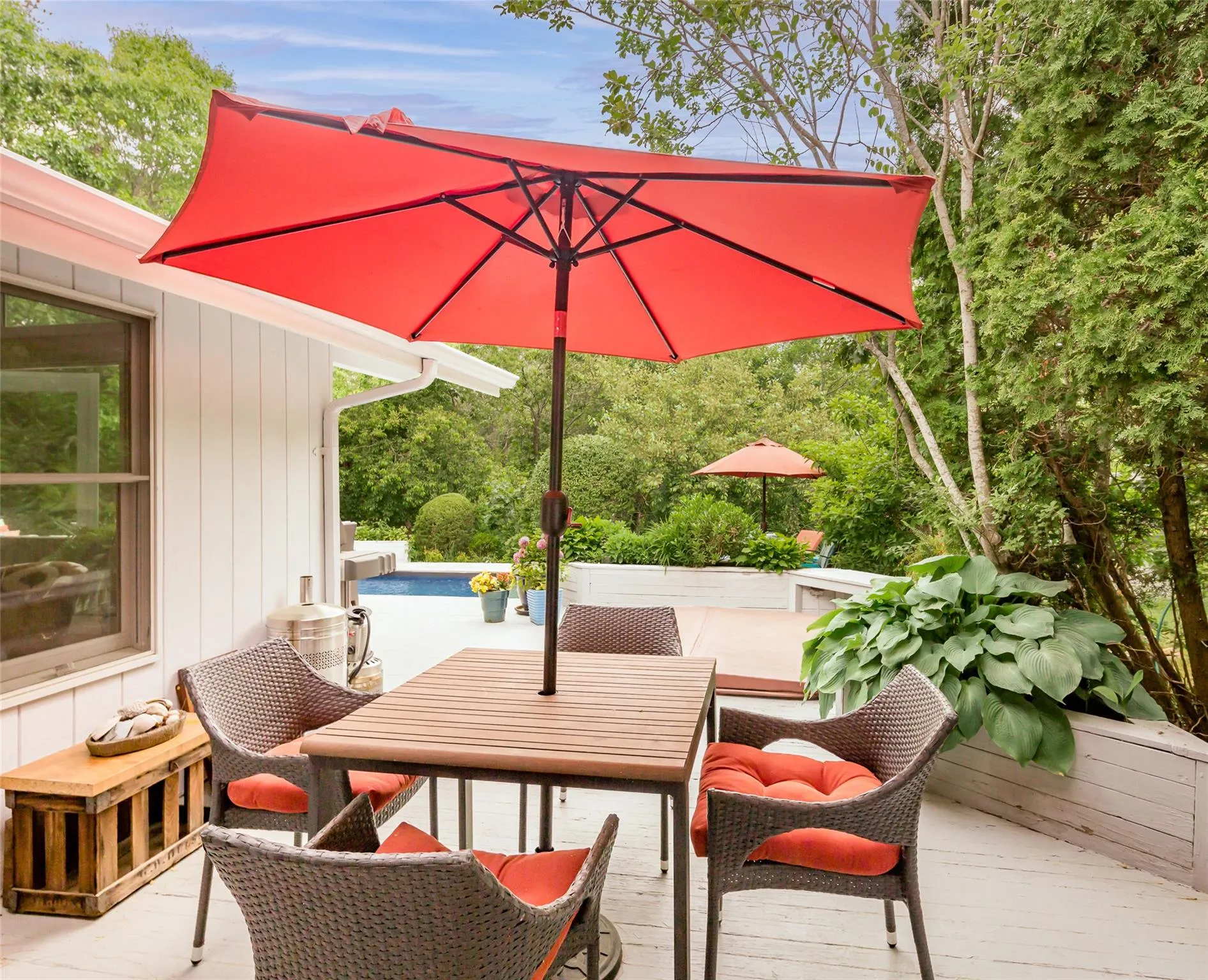 View of patio / terrace featuring an outdoor pool, a wooden deck, and outdoor dining space View of patio / terrace featuring an outdoor pool, a wooden deck, and outdoor dining space