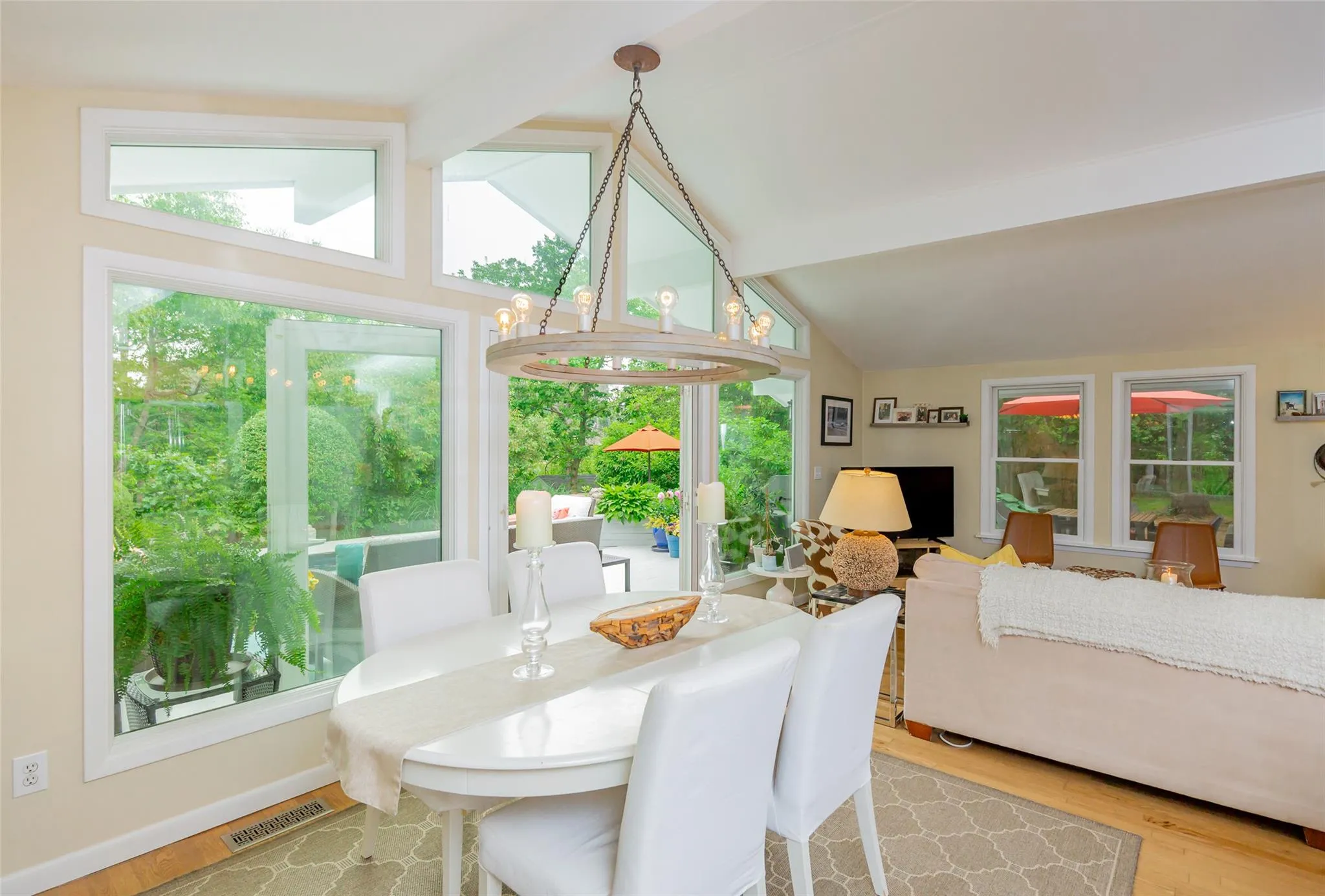 Dining room with lofted ceiling with beams, a wealth of natural light, and wood finished floors Dining room with lofted ceiling with beams, a wealth of natural light, and wood finished floors