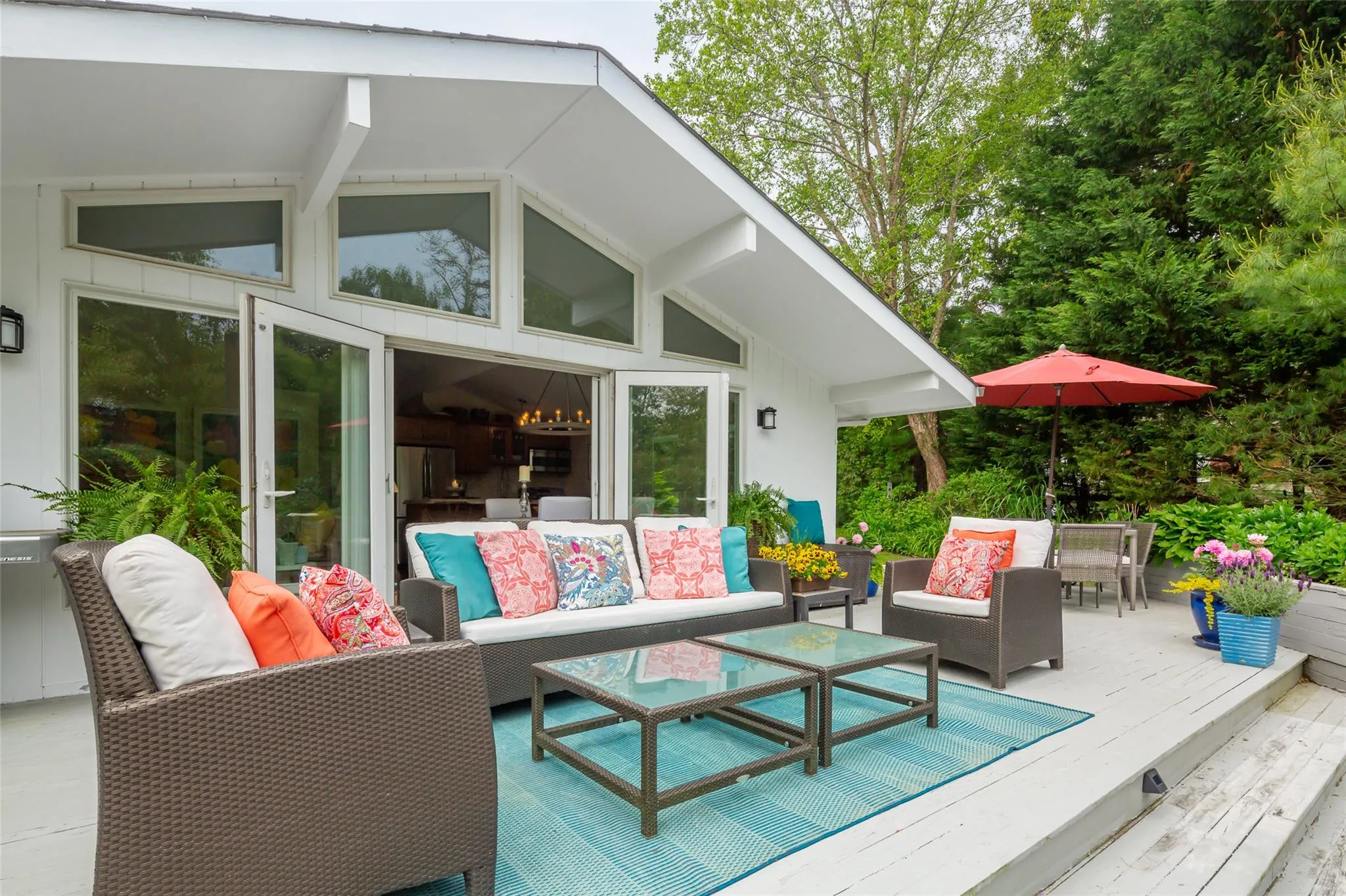 Wooden terrace featuring outdoor dining area and outdoor lounge area Wooden terrace featuring outdoor dining area and outdoor lounge area