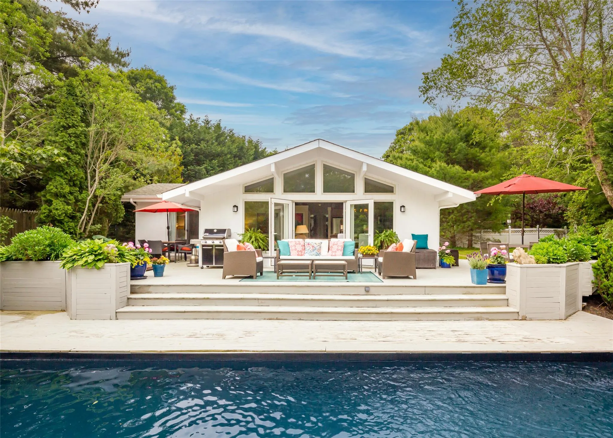 Back of house featuring an outdoor living space, a fenced in pool, and stucco siding Back of house featuring an outdoor living space, a fenced in pool, and stucco siding