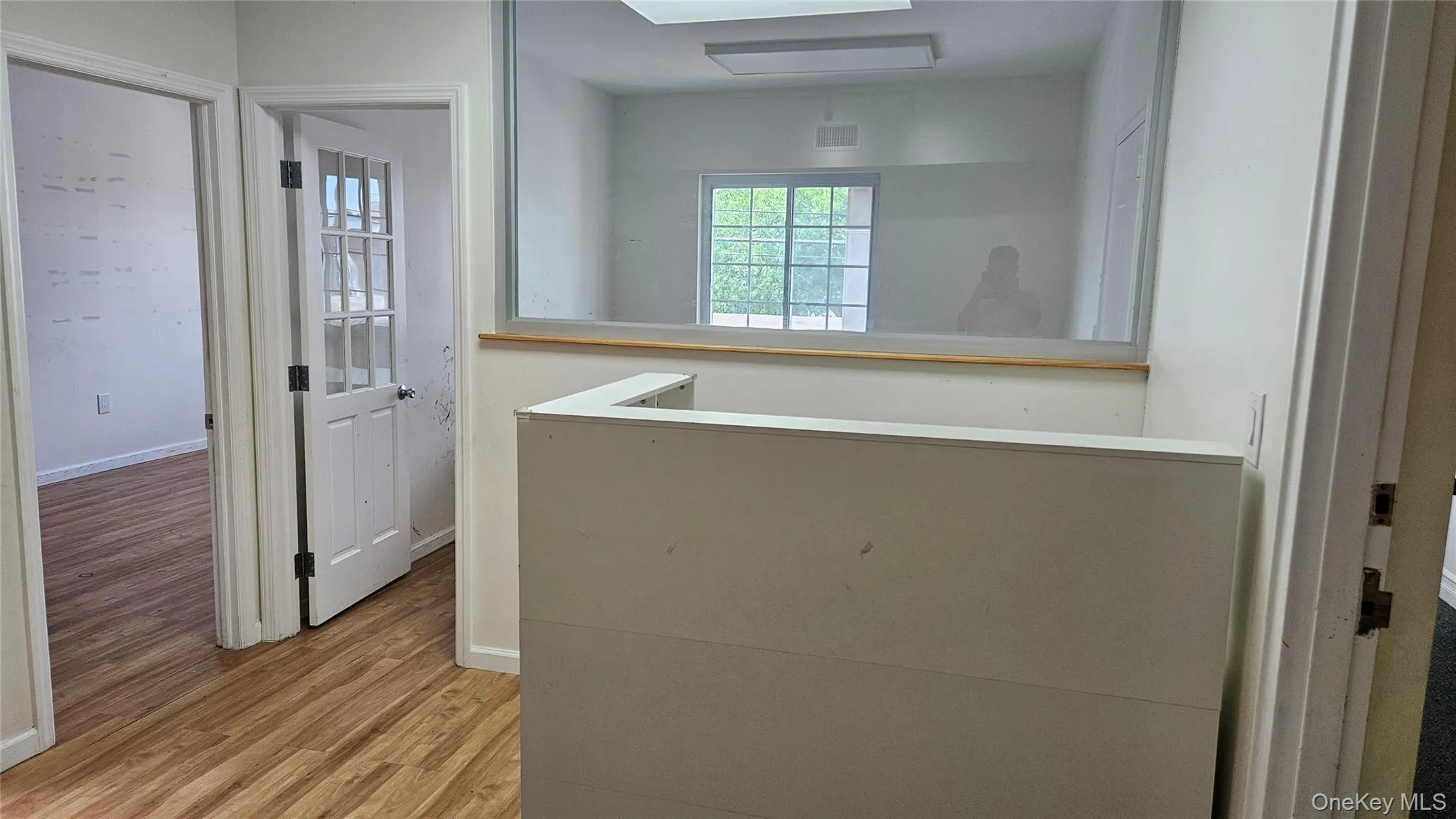 Hallway with light wood-type flooring and baseboards Hallway with light wood-type flooring and baseboards