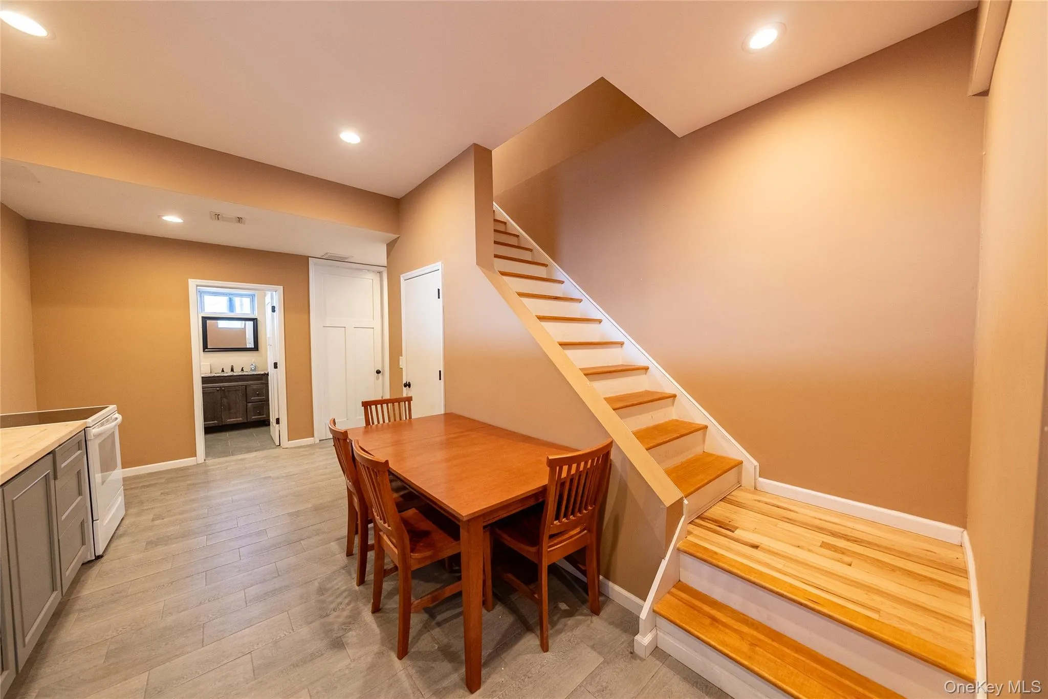 Kitchenette featuring light hardwood / wood-style flooring Kitchenette featuring light hardwood / wood-style flooring