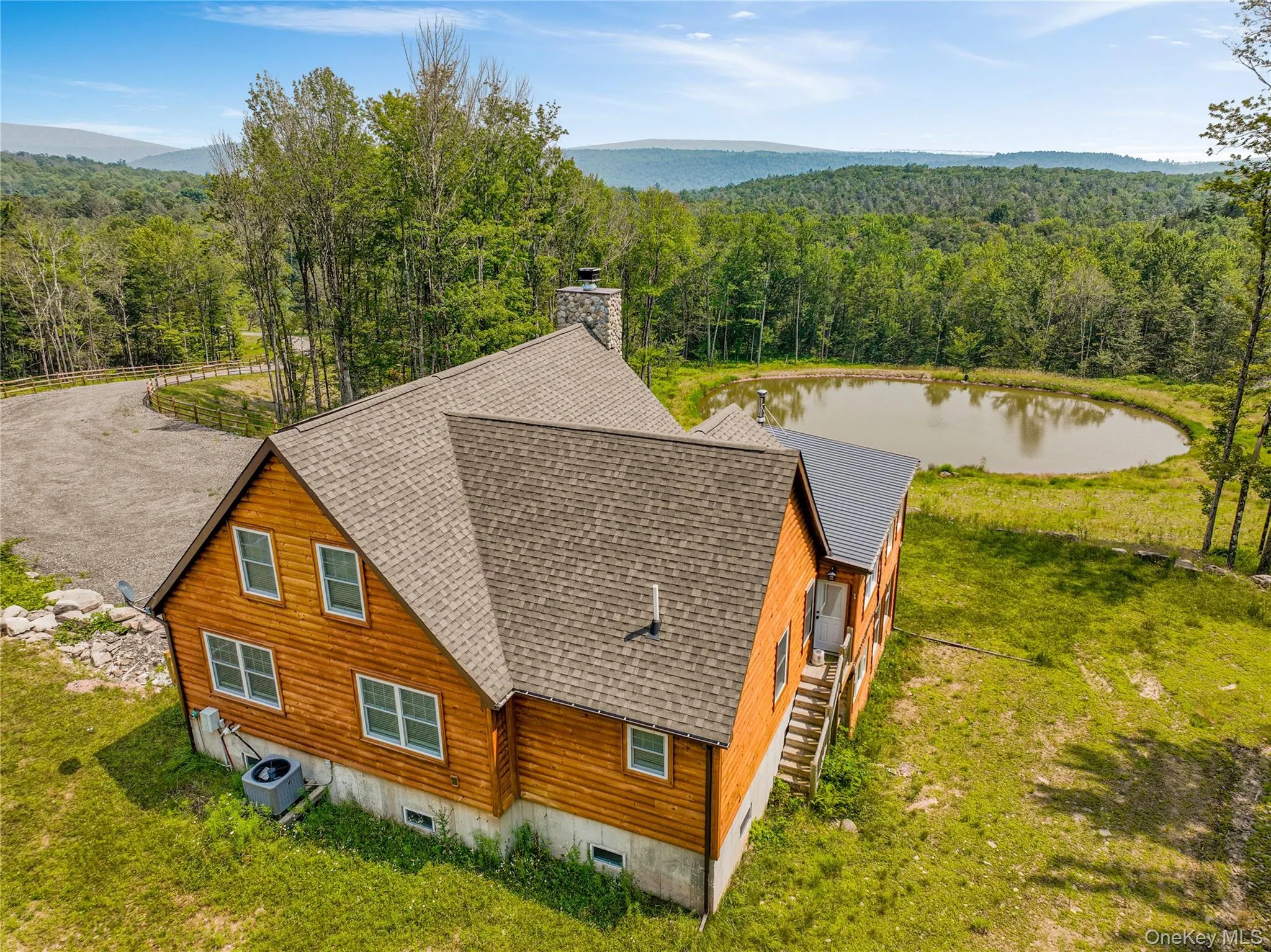 Aerial view of property and surrounding area featuring a forest and a large body of water Aerial view of property and surrounding area featuring a forest and a large body of water
