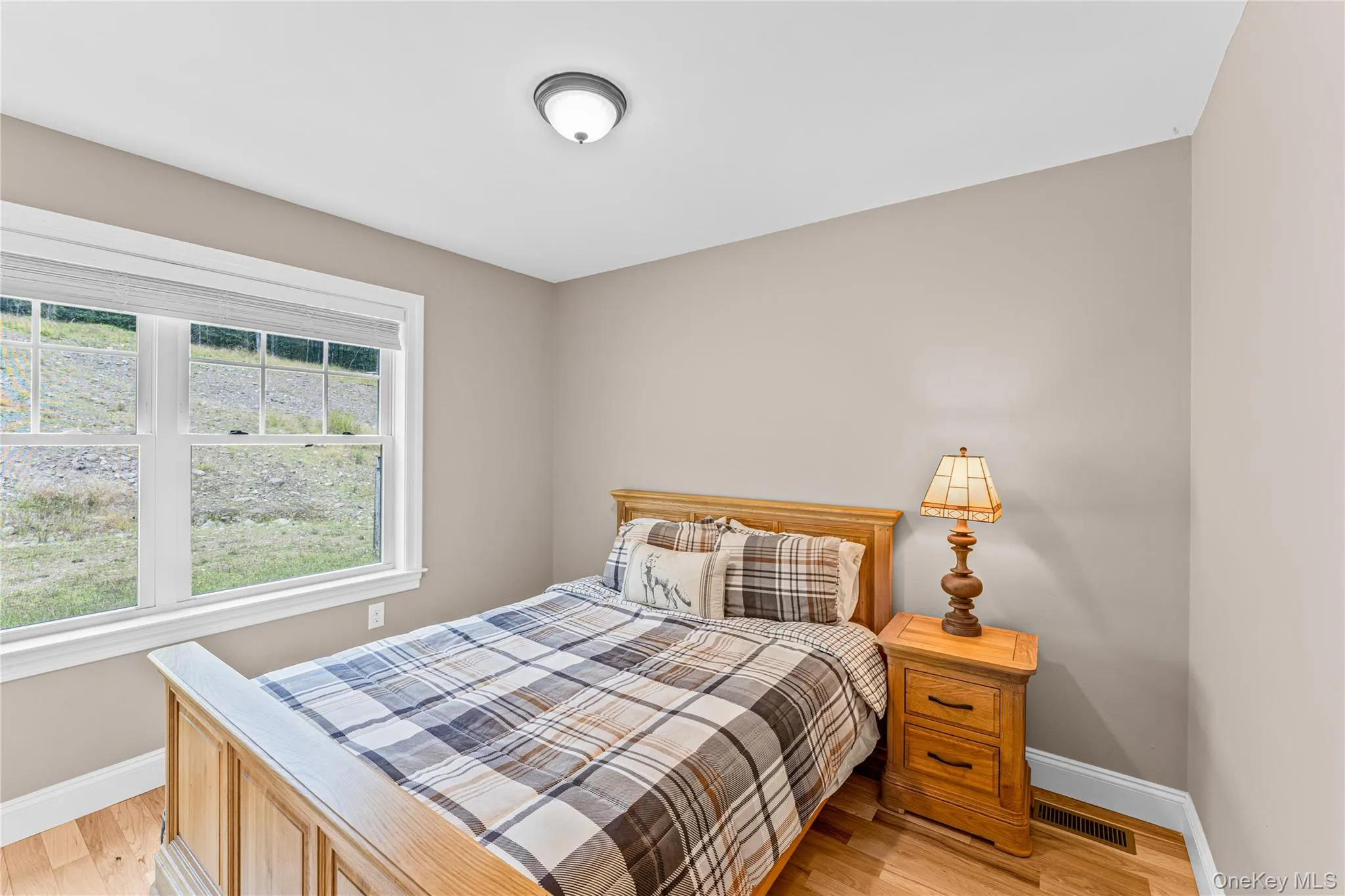 Bedroom 3 with light wood finished floors and baseboards Bedroom 3 with light wood finished floors and baseboards